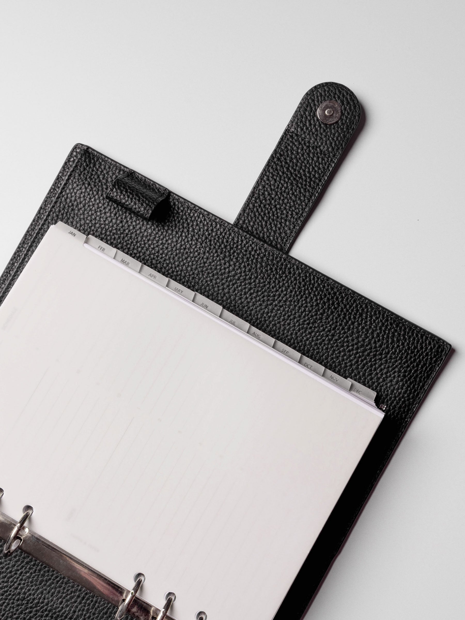 A5 vellum dividers shown in a leather agenda at an angle.