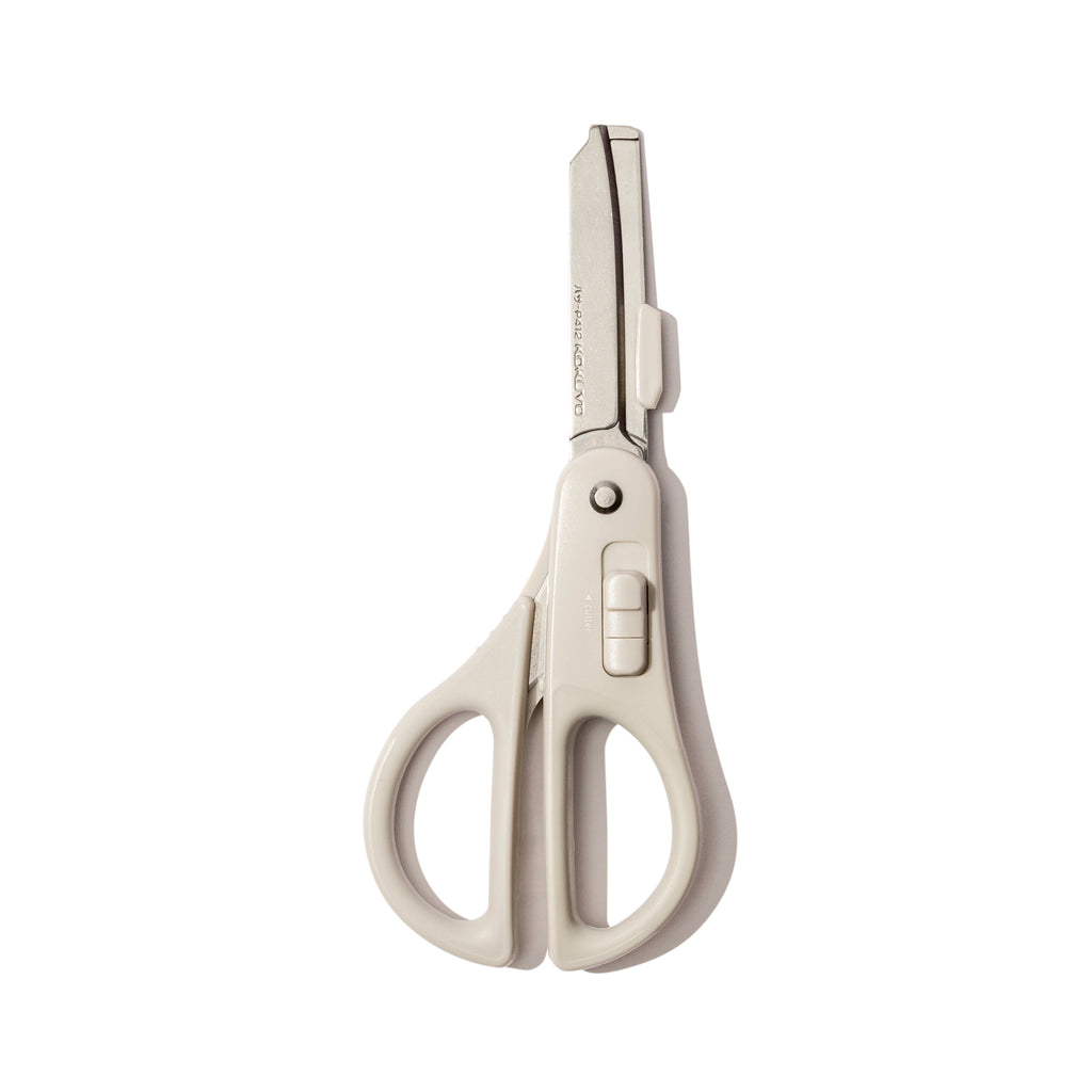 Scissors with blade exposed displayed on a white background.