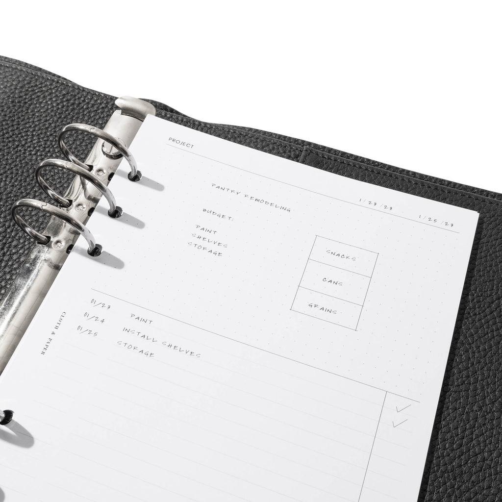 Insert in use inside of a black leather agenda. Each section is filled out with sample text. Size pictured is A5. 