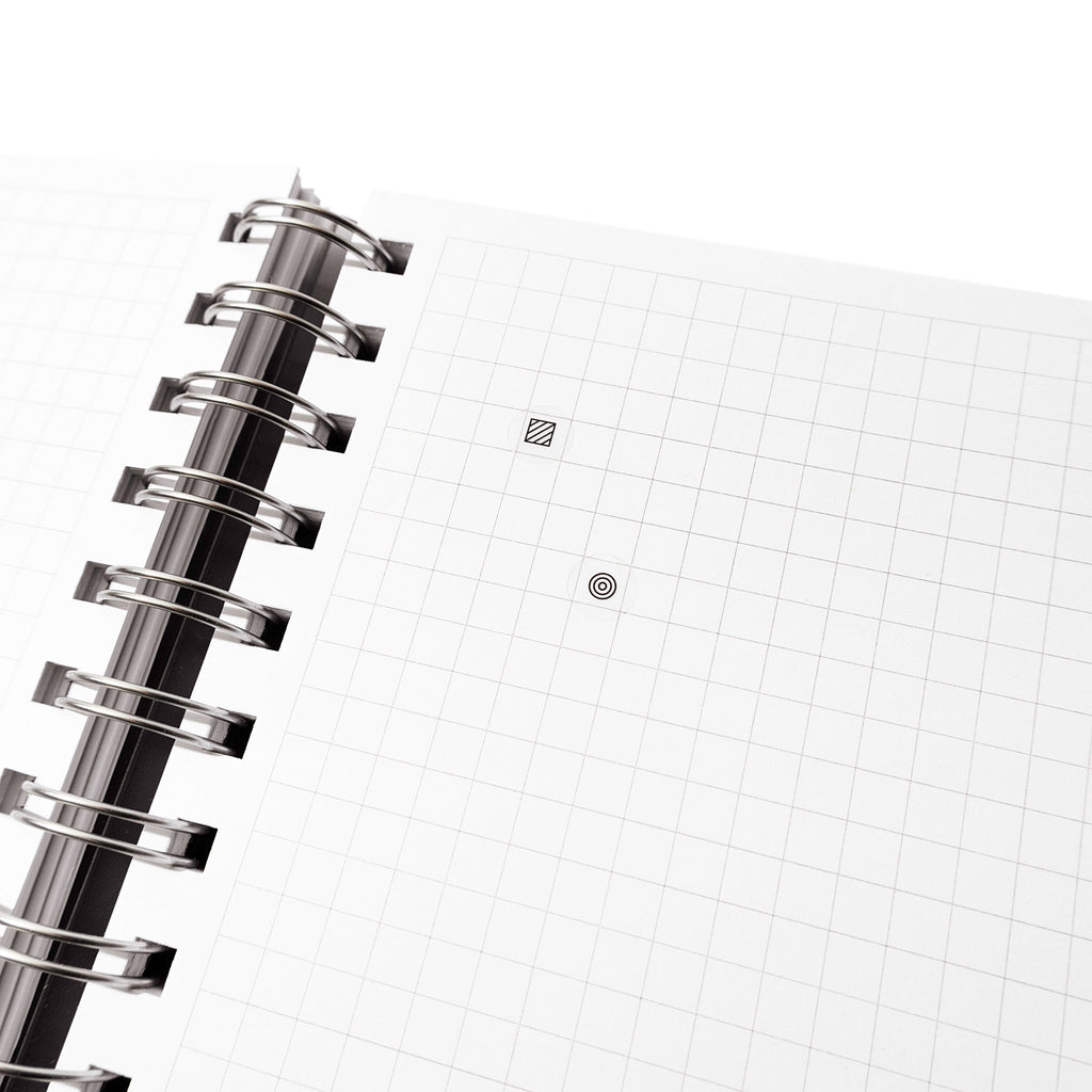 Two Bujo stickers shown in a grid notebook. One is a square design, the other a circle.
