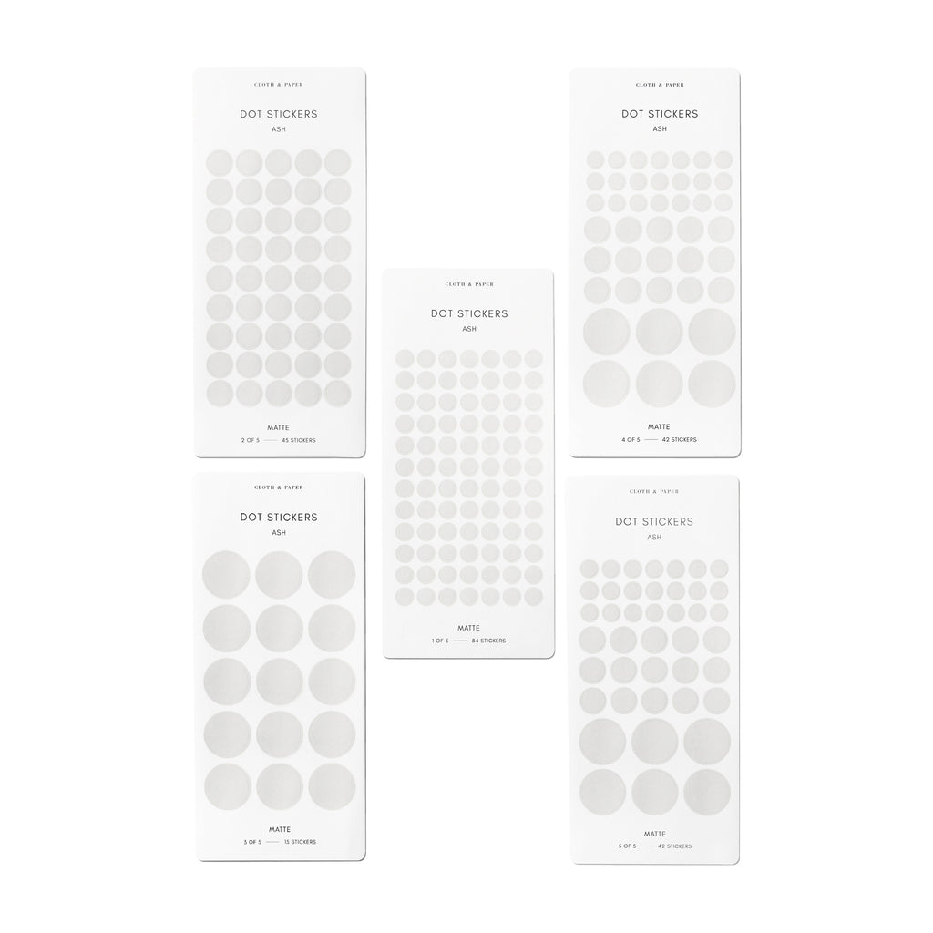 Five sheets of Ash stickers in varying sizes are arranged paralell to each other on a white background.