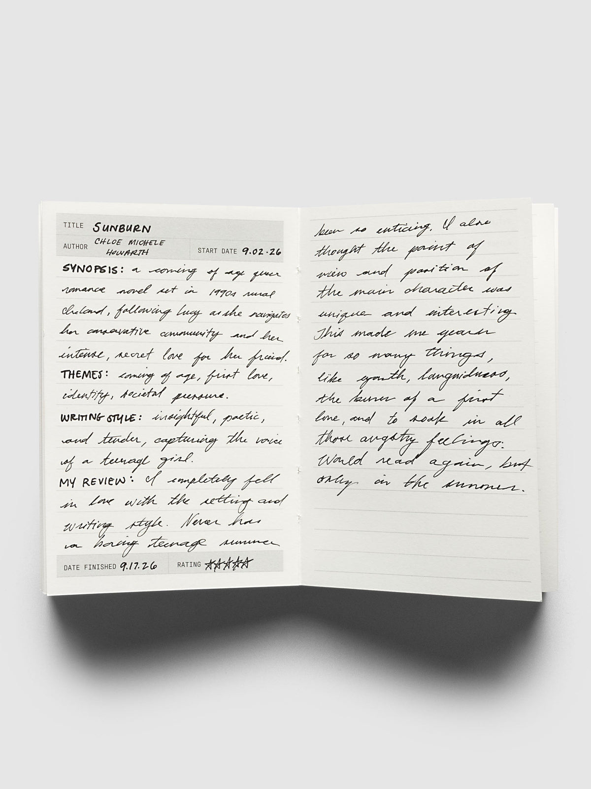 Bibliophile Notebook Pocket, open to a reading log spread filled in by hand