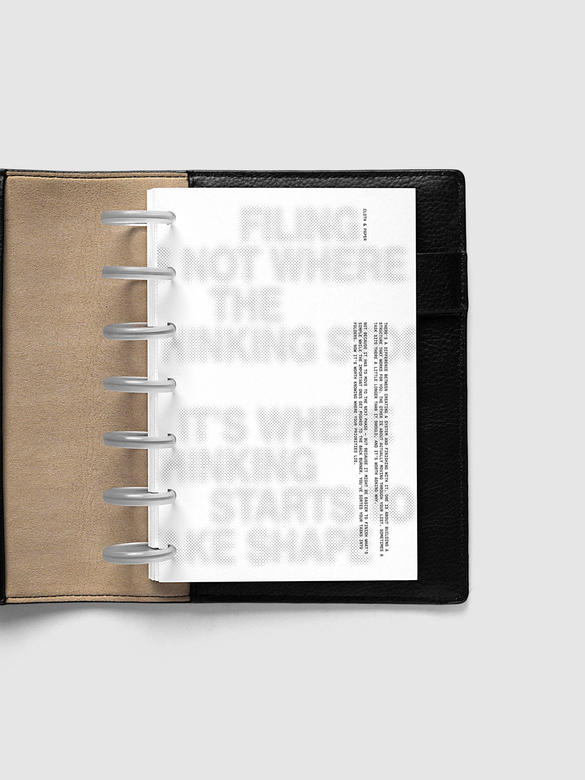 Halftone Planner Dashboard, HP Mini 7-Disc Punch, dashboard on frosted discs in an open black leather planner with a kraft interior panel