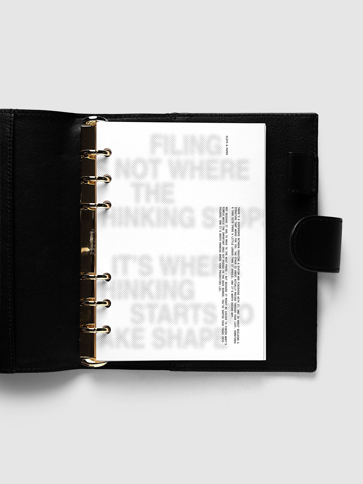 Halftone Planner Dashboard, Personal Wide 6-Ring Punch, dashboard on the rings of an open black leather planner, the grey halftone headline across the page