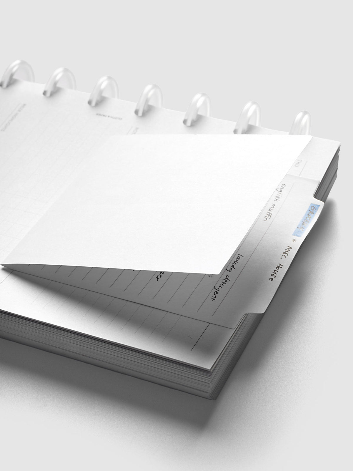 Large Sticky Notes Tab Lined, angled view of the tab rising above the top edge of a planner
