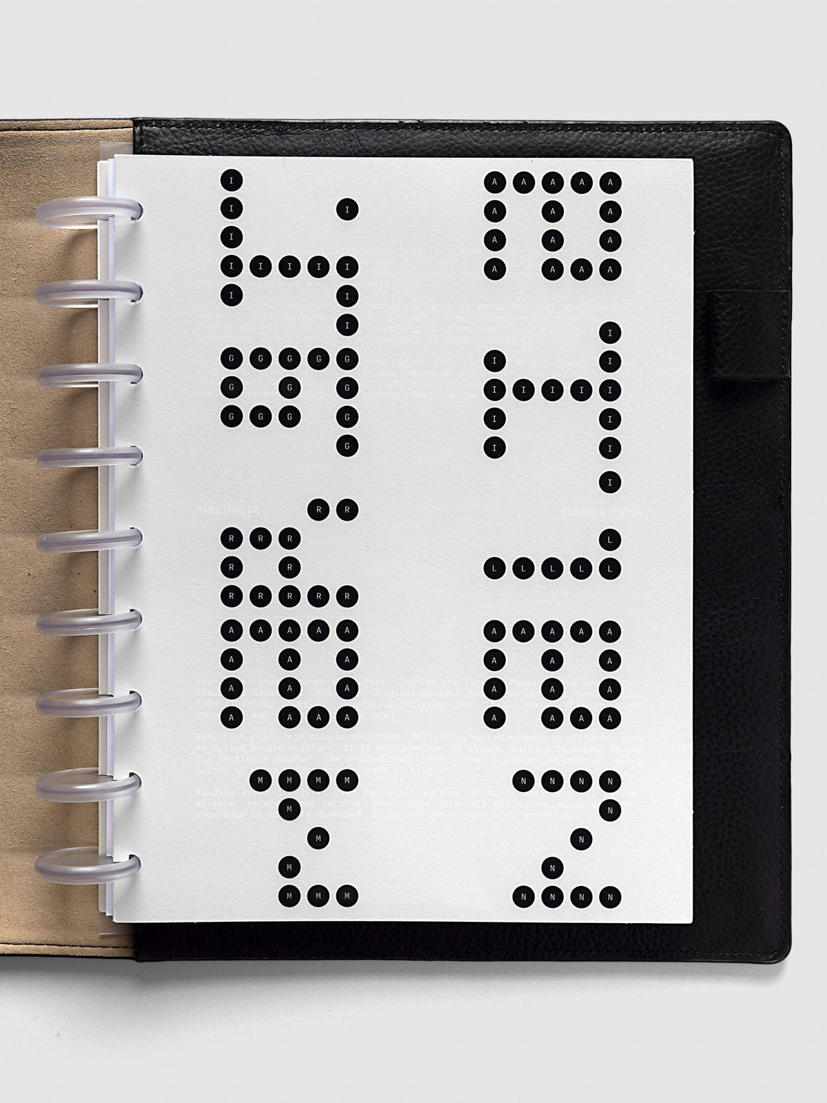 Scantron Dashboard Duo, HP Classic 9-Disc Punch, the dashboard pair on frosted discs in an open black leather planner with a kraft interior panel