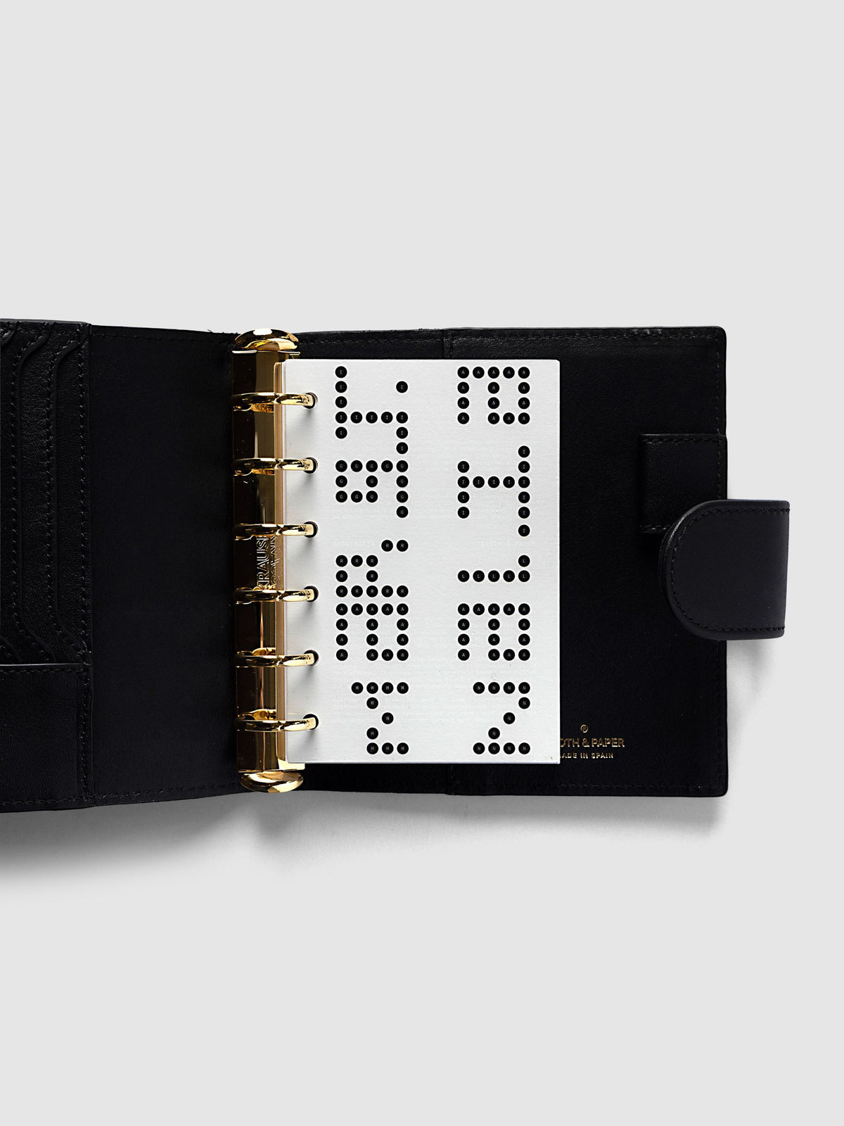 Scantron Dashboard Duo, Pocket 6-Ring Punch, the dashboard pair on the rings of an open black leather planner