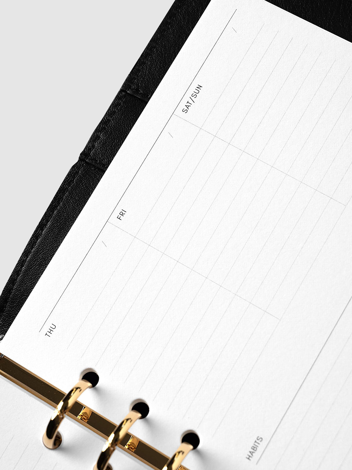 Weekly Essentials Planner Inserts, A5 6-Ring Punch, angled close-up of the Friday, Saturday and Sunday columns at the top of the right-hand page