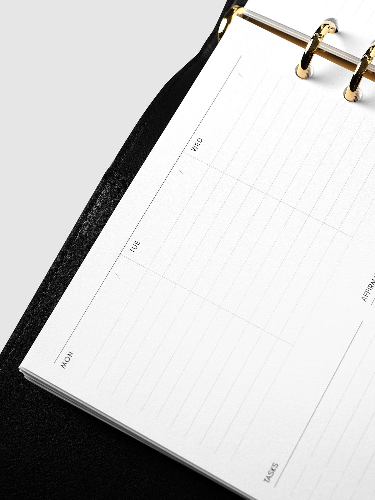 Weekly Essentials Planner Inserts, A5 6-Ring Punch, angled close-up of the Monday, Tuesday and Wednesday columns at the top of the left-hand page