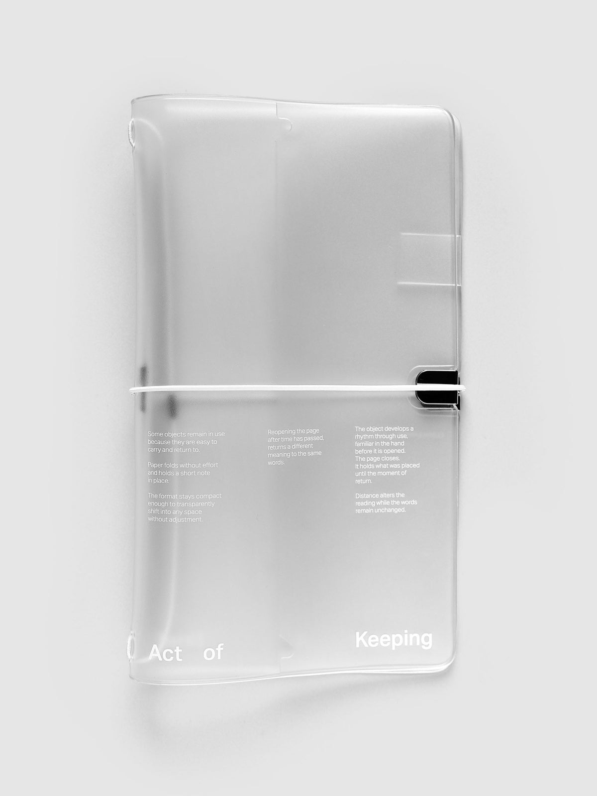 Act of Keeping Travel Cover, A5 Slim, in frosted vinyl printed in white with Act of Keeping and three short passages, closed with a white elastic cord and black clip