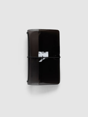 Image Duo Travel Cover, Pocket Plus, in tinted black vinyl, closed with a black elastic cord across the white halftone photo print