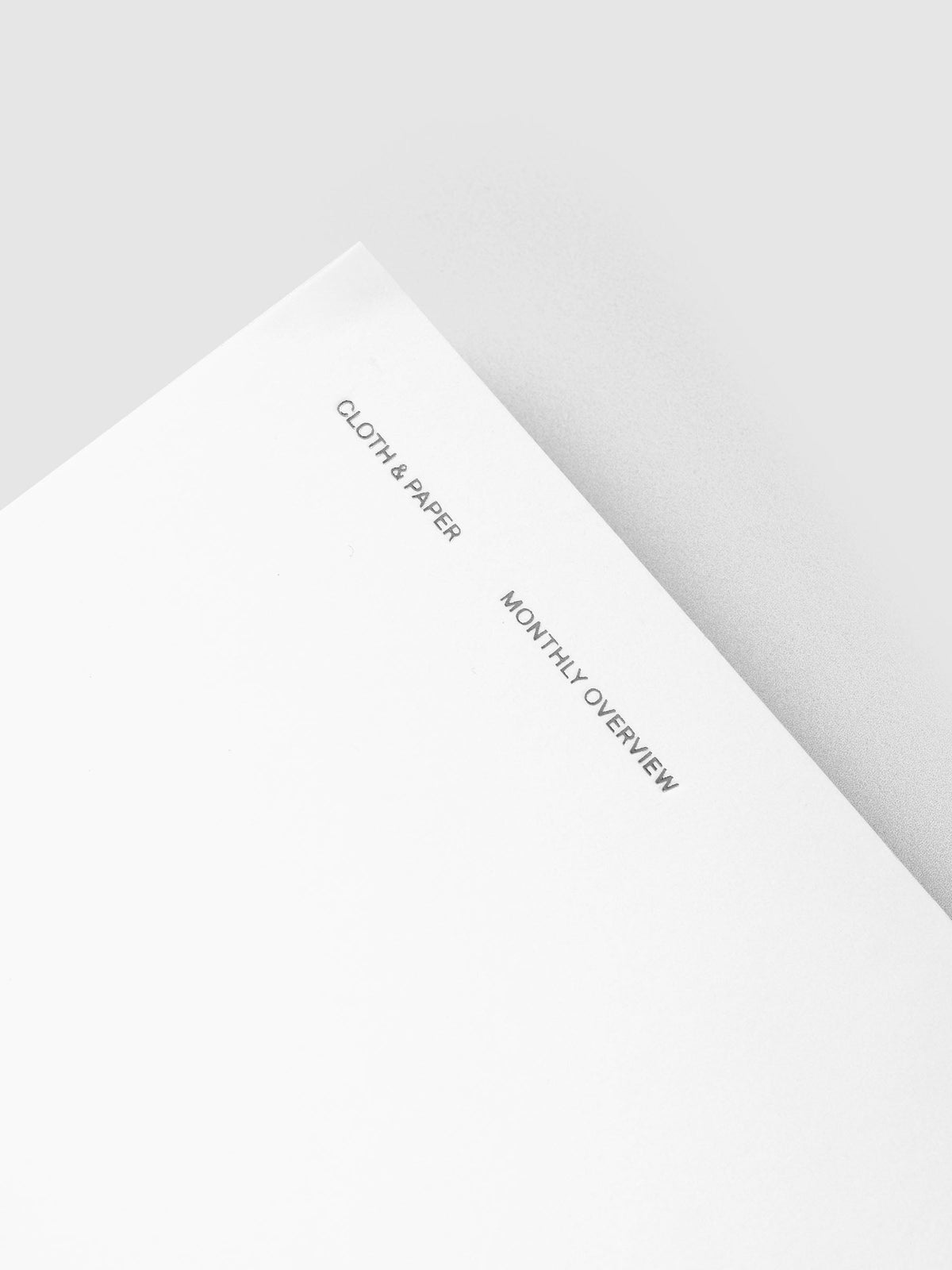 Close-up of the silver foil Cloth & Paper and Monthly Overview lettering on the white Le Blanc cover