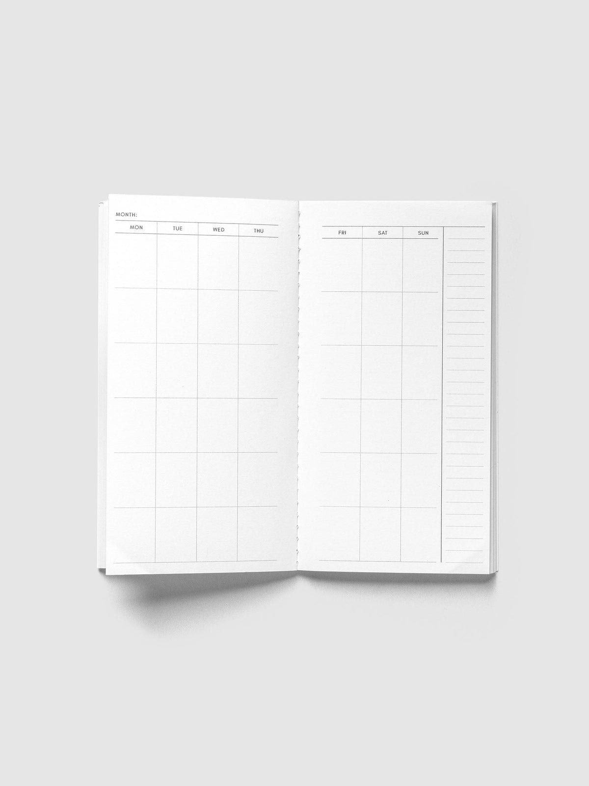 Monthly Overview Pocket Plus open to an undated Monday to Sunday month calendar spread with a lined notes column