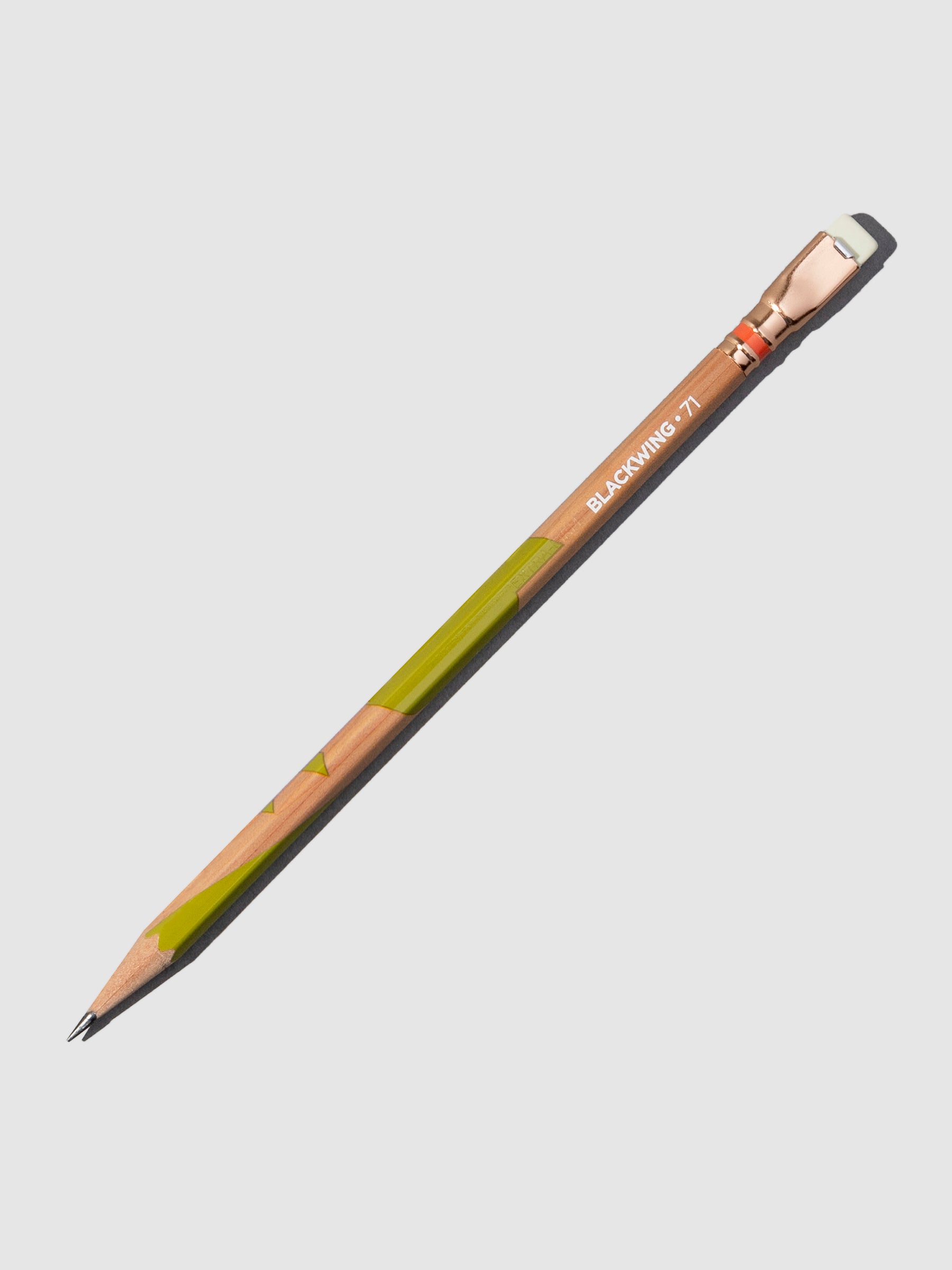 Wooden pencil with green accents displayed on a neutral background.