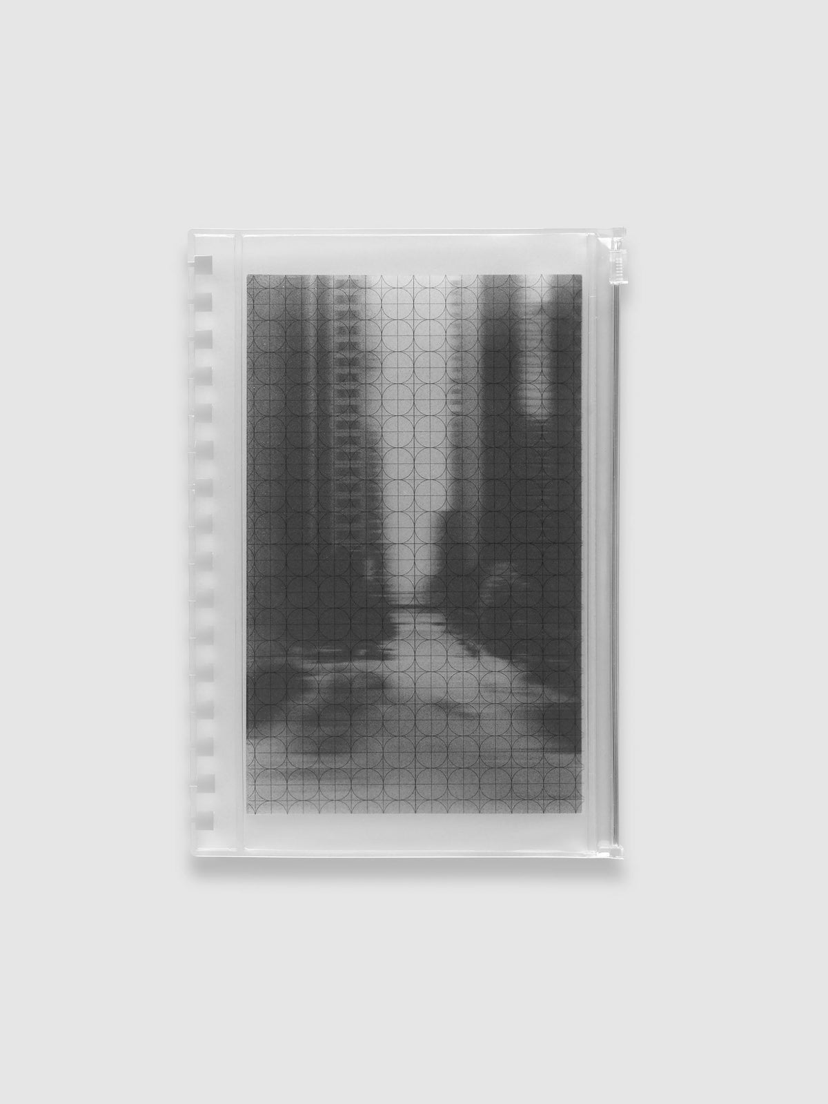 Frosted transparent zippered storage pouch pre-punched for A5 Spiral notebooks, holding the black and white blurred photo insert under the clear circle and graph overlay. Shown in size A5 Spiral.