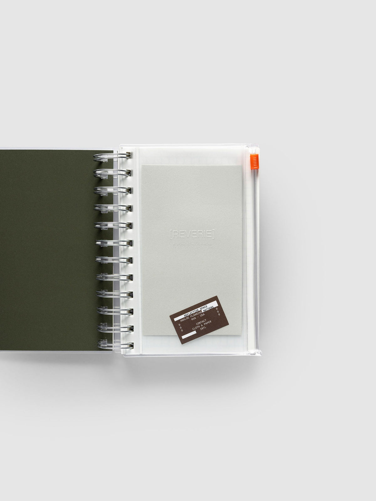 Reverie Storage Holder bound into a spiral notebook in size CP Petite Spiral, with the light grey embossed dashboard and brown sticker inside the clear pouch.