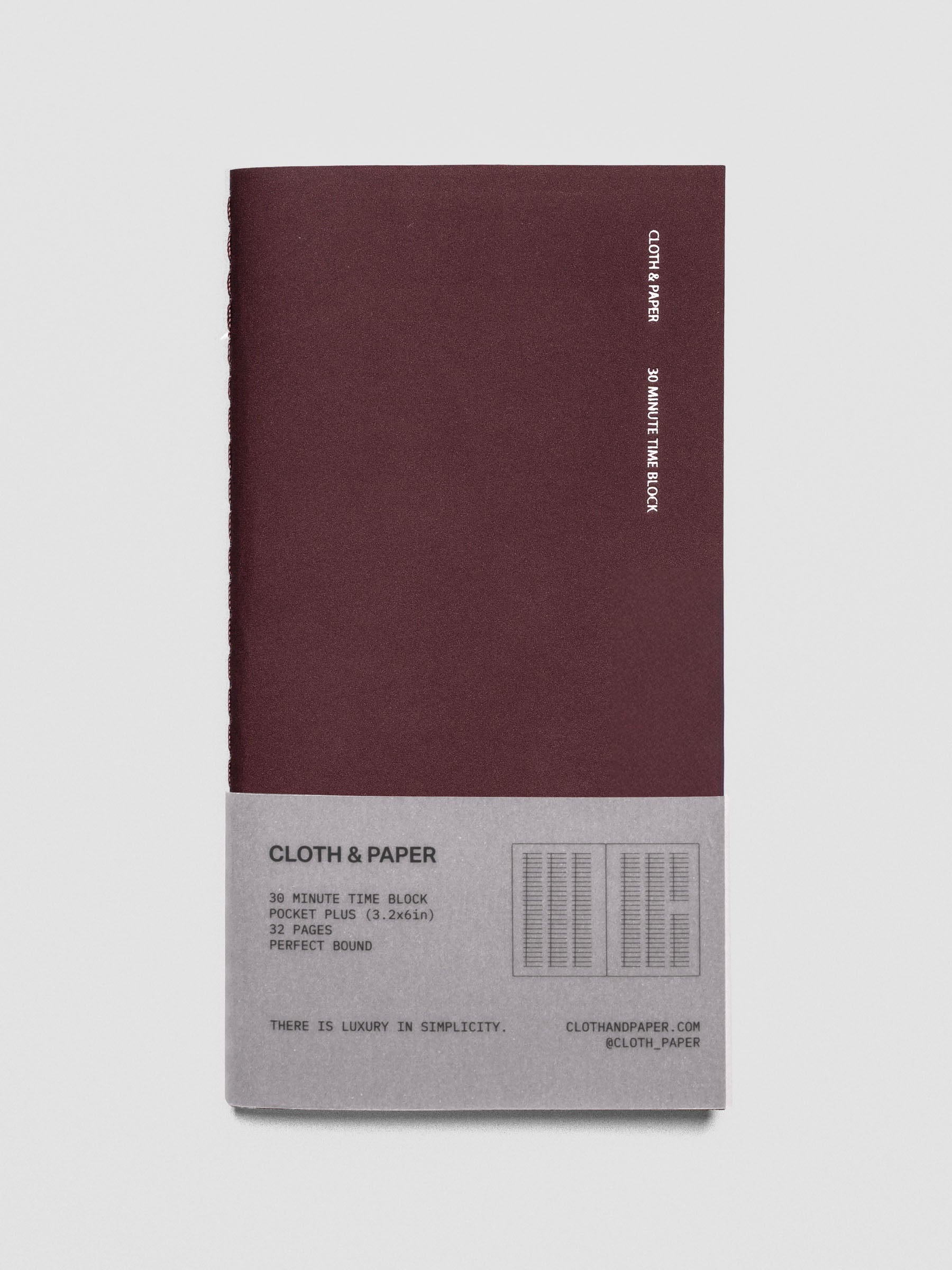 Front image of Travel Journal in size Pocket Plus in color Bordeux with 30 Minute Time Block pages shown with belly band packaging.