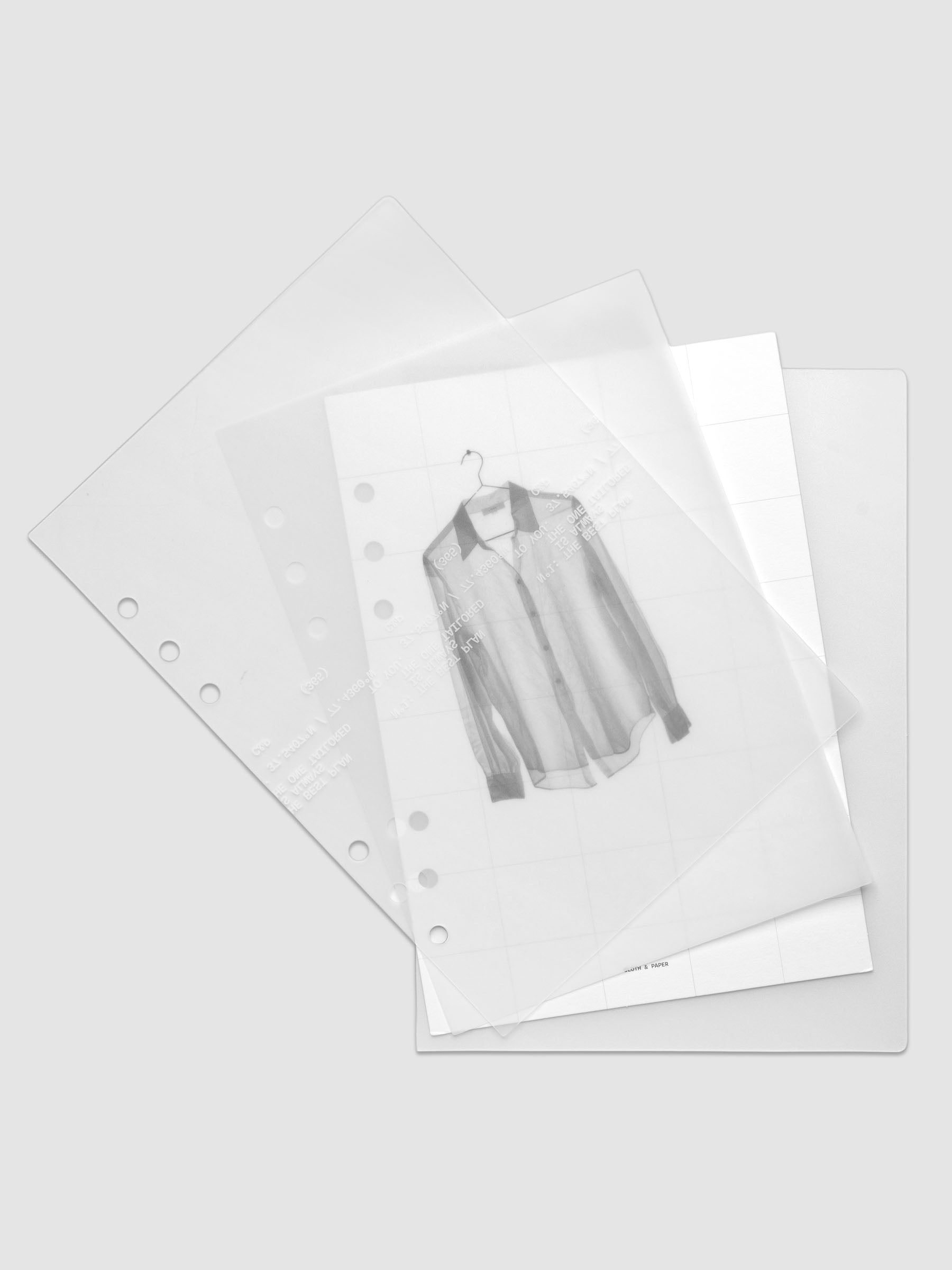 Transparent planner cover set with white printed text design and accompanying black and white dashboard with an image of a tailored shirt on a hanger shown offset. Pre-punched for 6-ring planners shown in size A5.