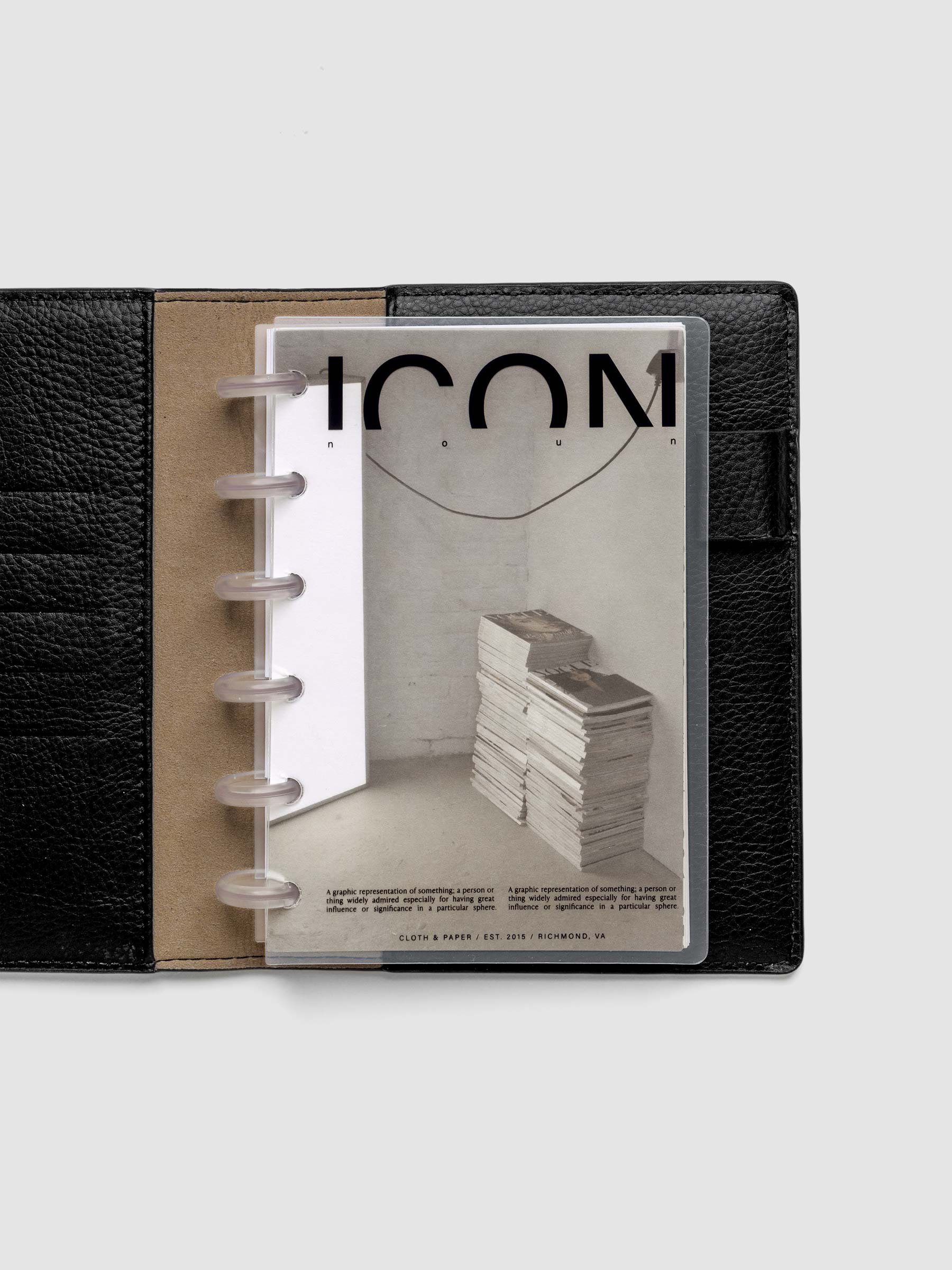 Clear planner cover with black text and a photographic dashboard shown pre-punched for discbound planners in size CP Petite in a black folio.