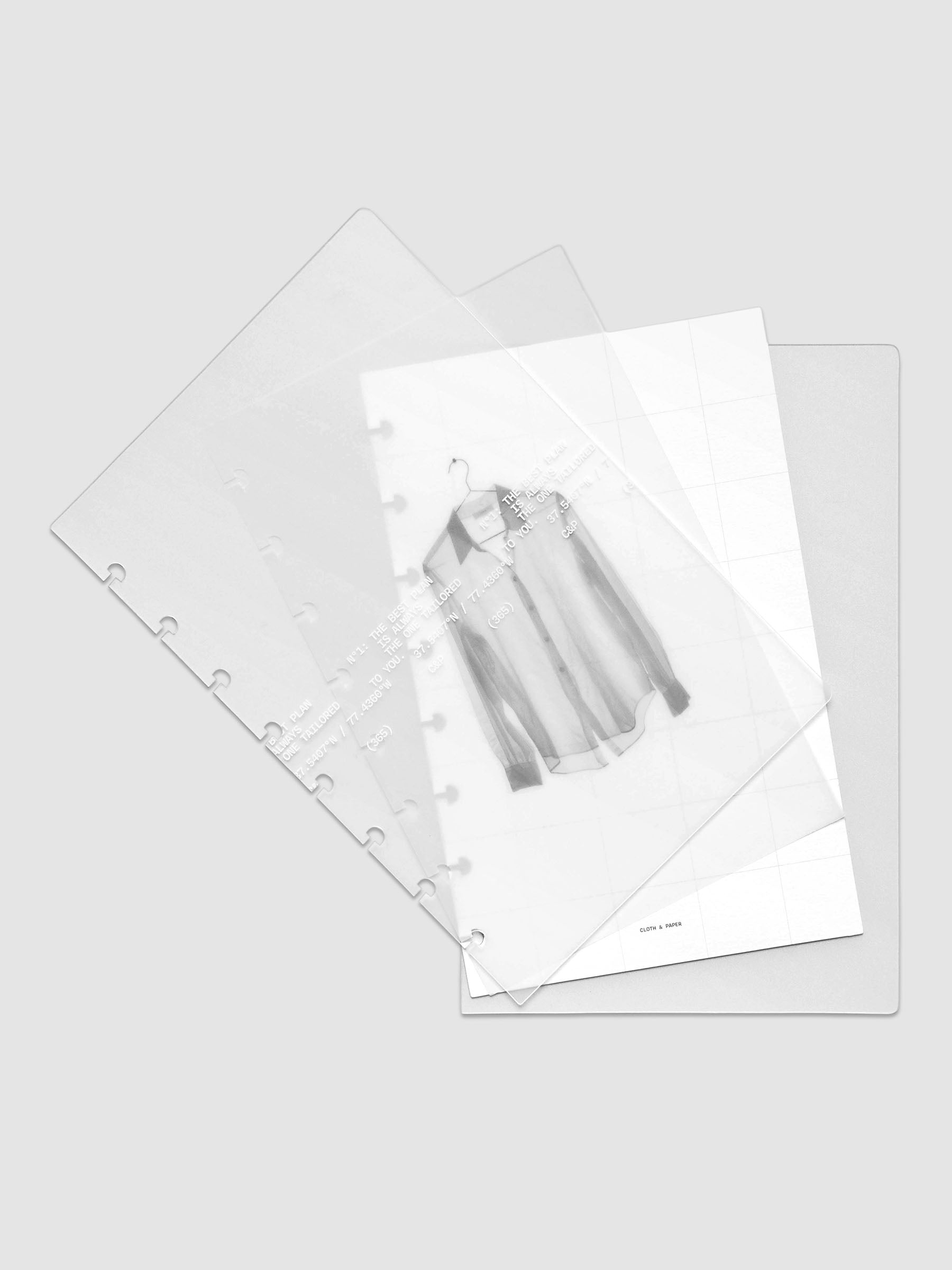 Transparent planner cover set with white printed text design and accompanying black and white dashboard with an image of a tailored shirt on a hanger shown offset. Pre-punched for discbound planners shown in size Half Letter.