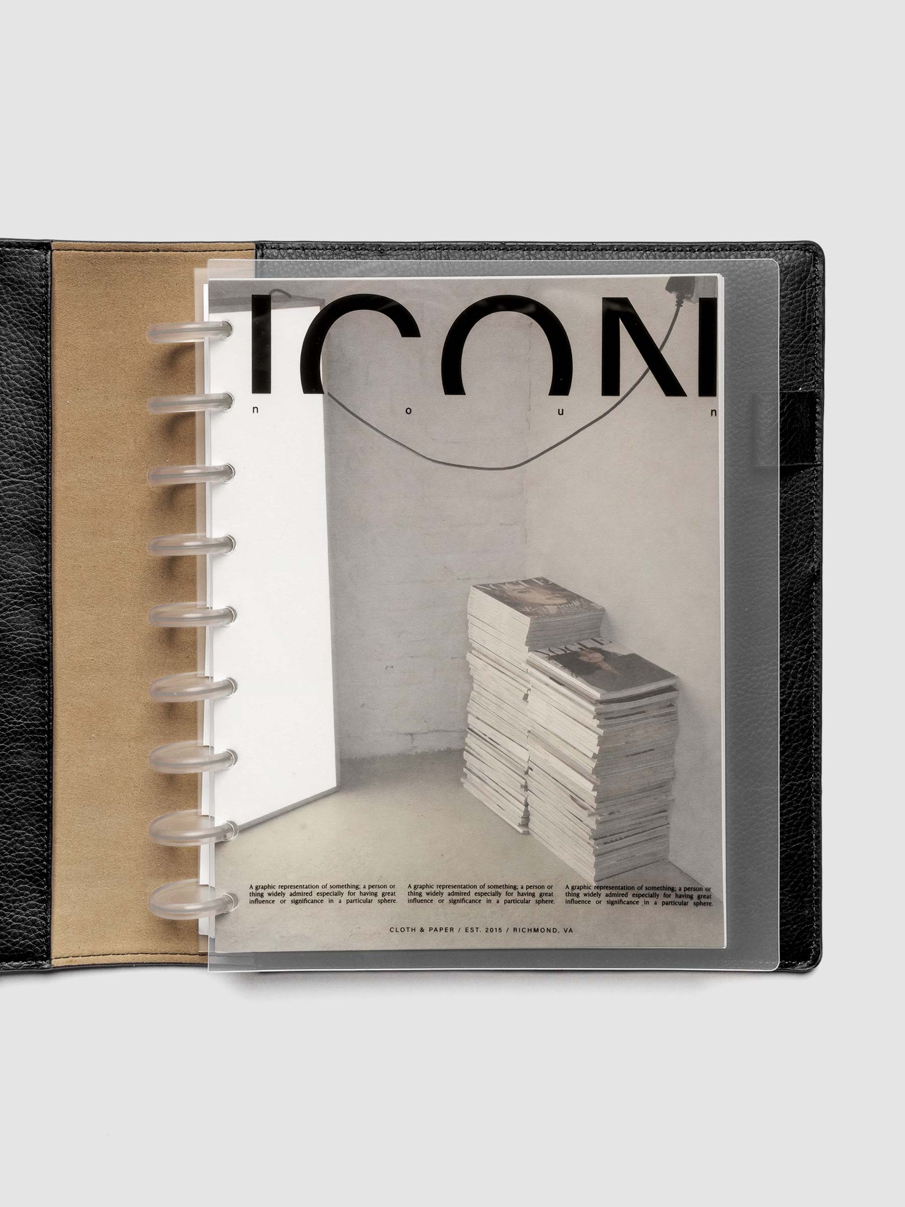 Clear planner cover with black text and a photographic dashboard shown pre-punched for discbound planners in size HP Classic in a black folio.