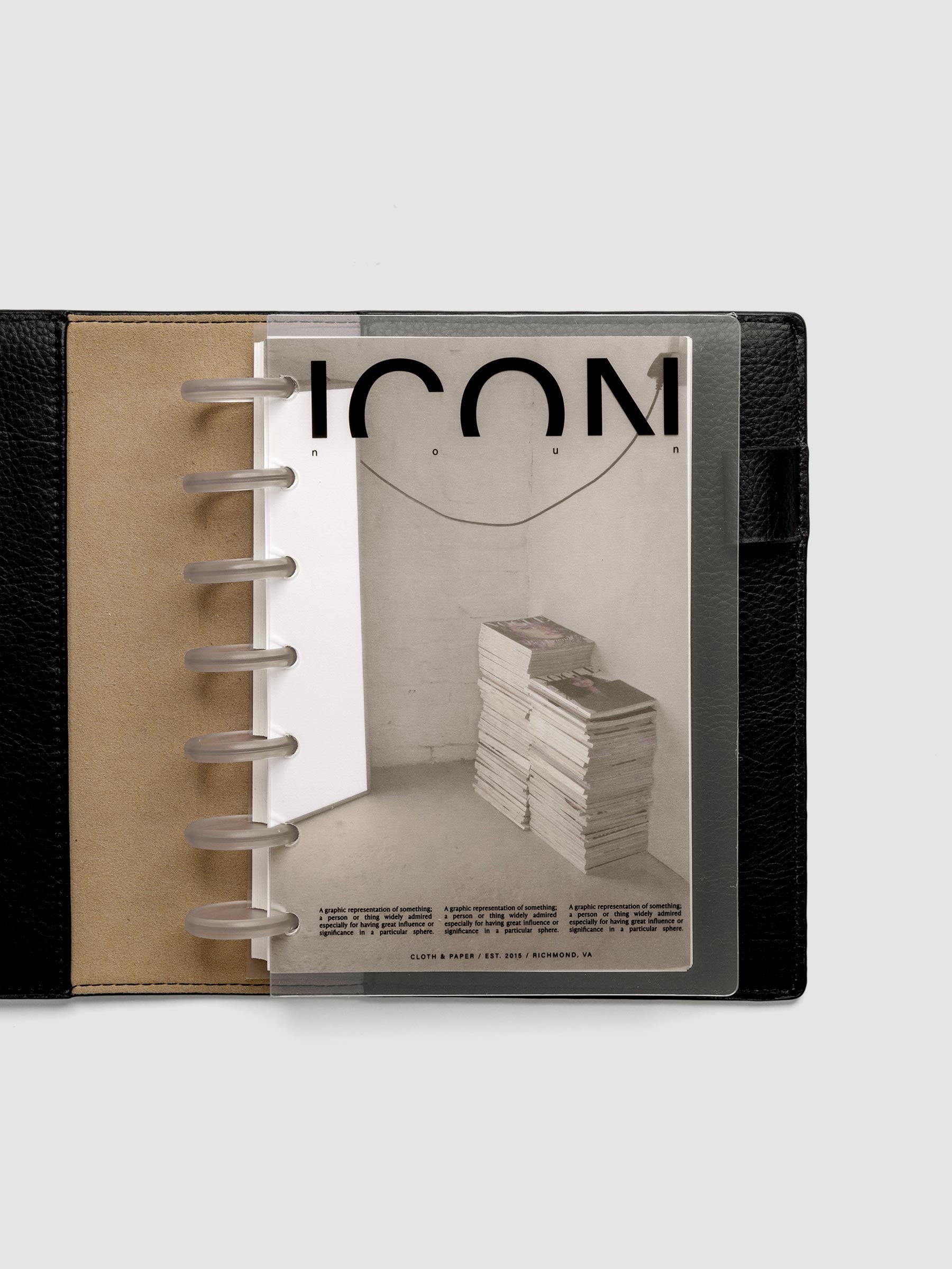 Clear planner cover with black text and a photographic dashboard shown pre-punched for discbound planners in size HP Mini in a black folio.