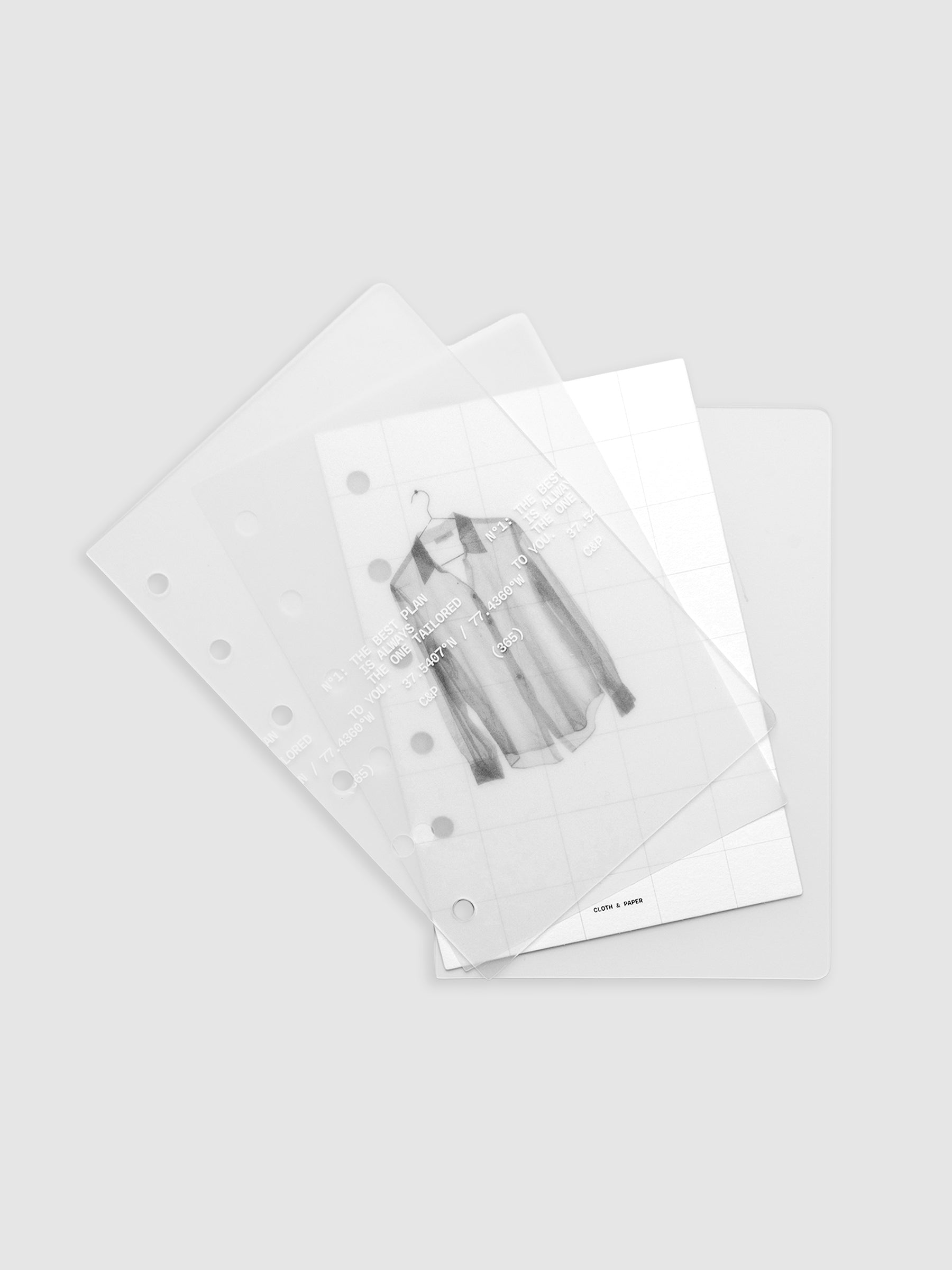 Transparent planner cover set with white printed text design and accompanying black and white dashboard with an image of a tailored shirt on a hanger shown offset. Pre-punched for 6-ring planners shown in size Pocket.