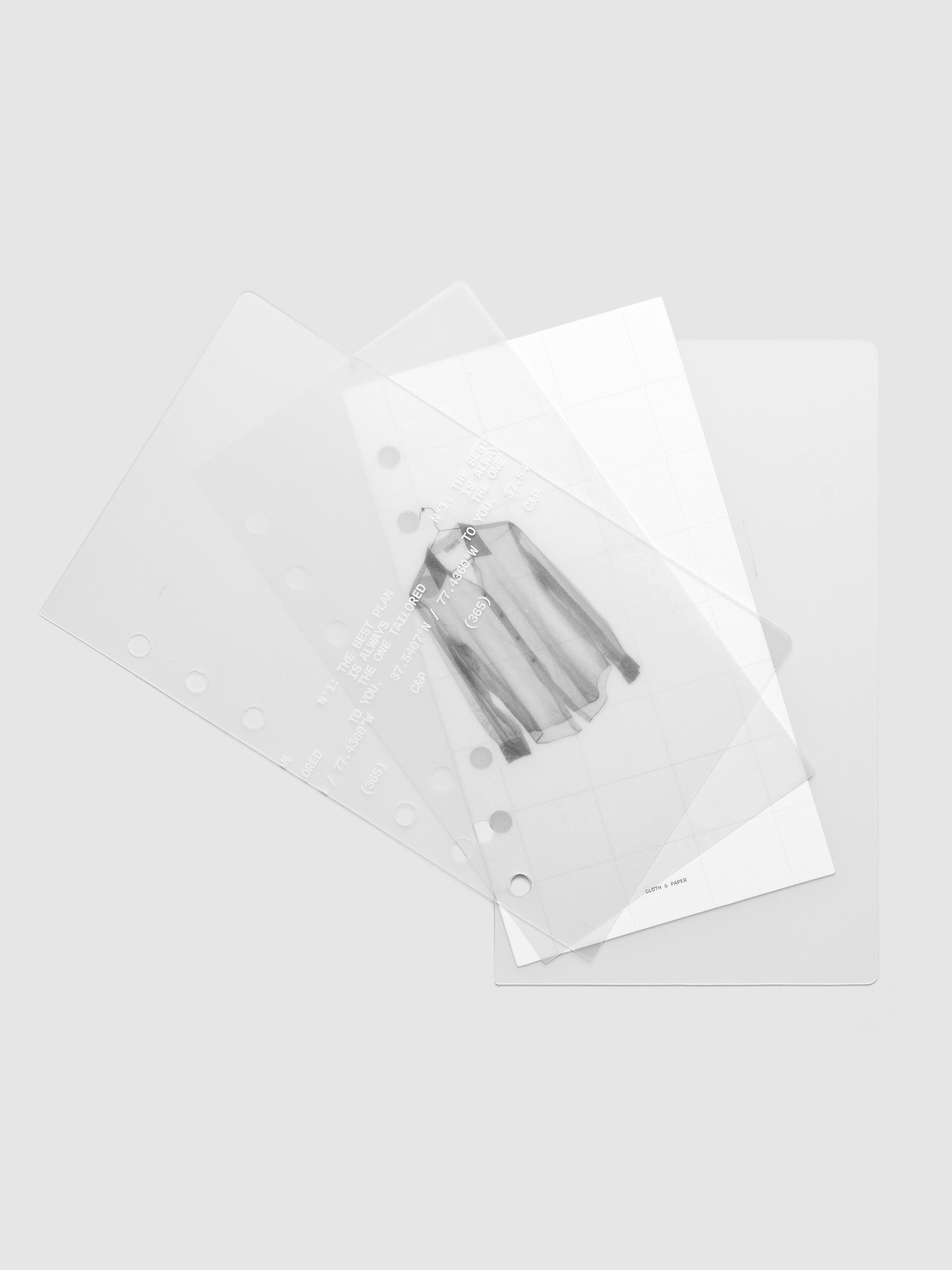 Transparent planner cover set with white printed text design and accompanying black and white dashboard with an image of a tailored shirt on a hanger shown offset. Pre-punched for 6-ring planners shown in size Personal.