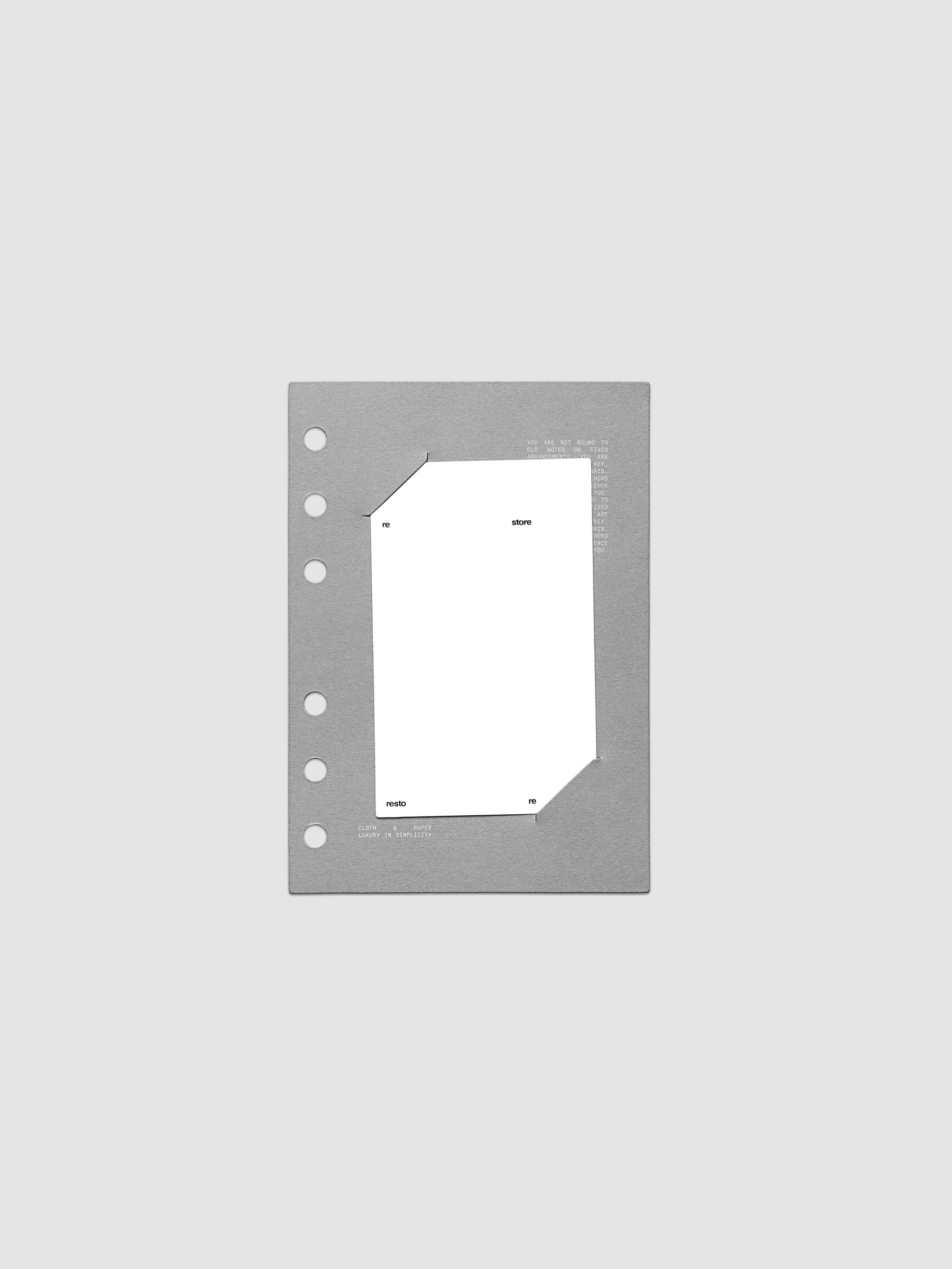 Grey cardstock planner dashboard with white plastic card inserted in slits with white printed text shown in size A6 for ring bound planners.