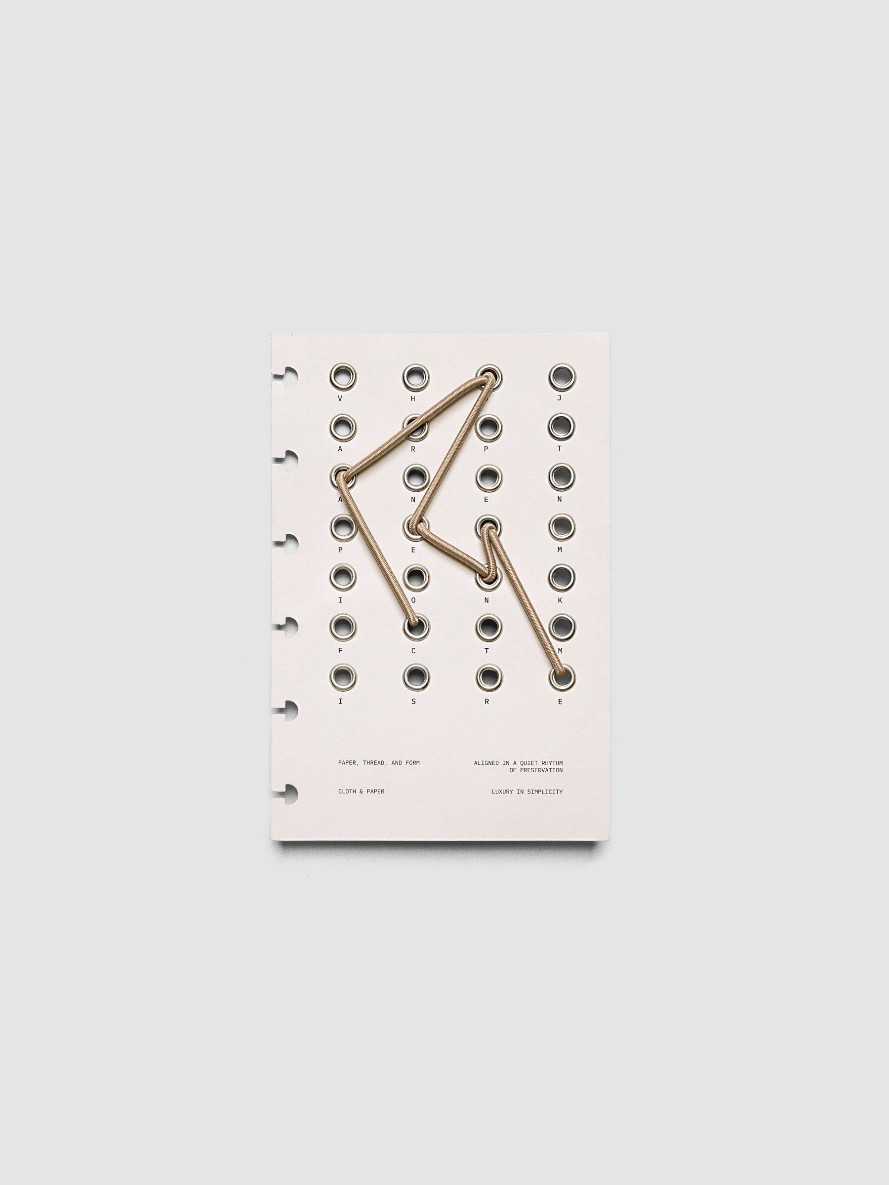 Cadence Dashboard with grommets and string on beige cardstock shown in size CP Petite for discbound planners and notebooks.