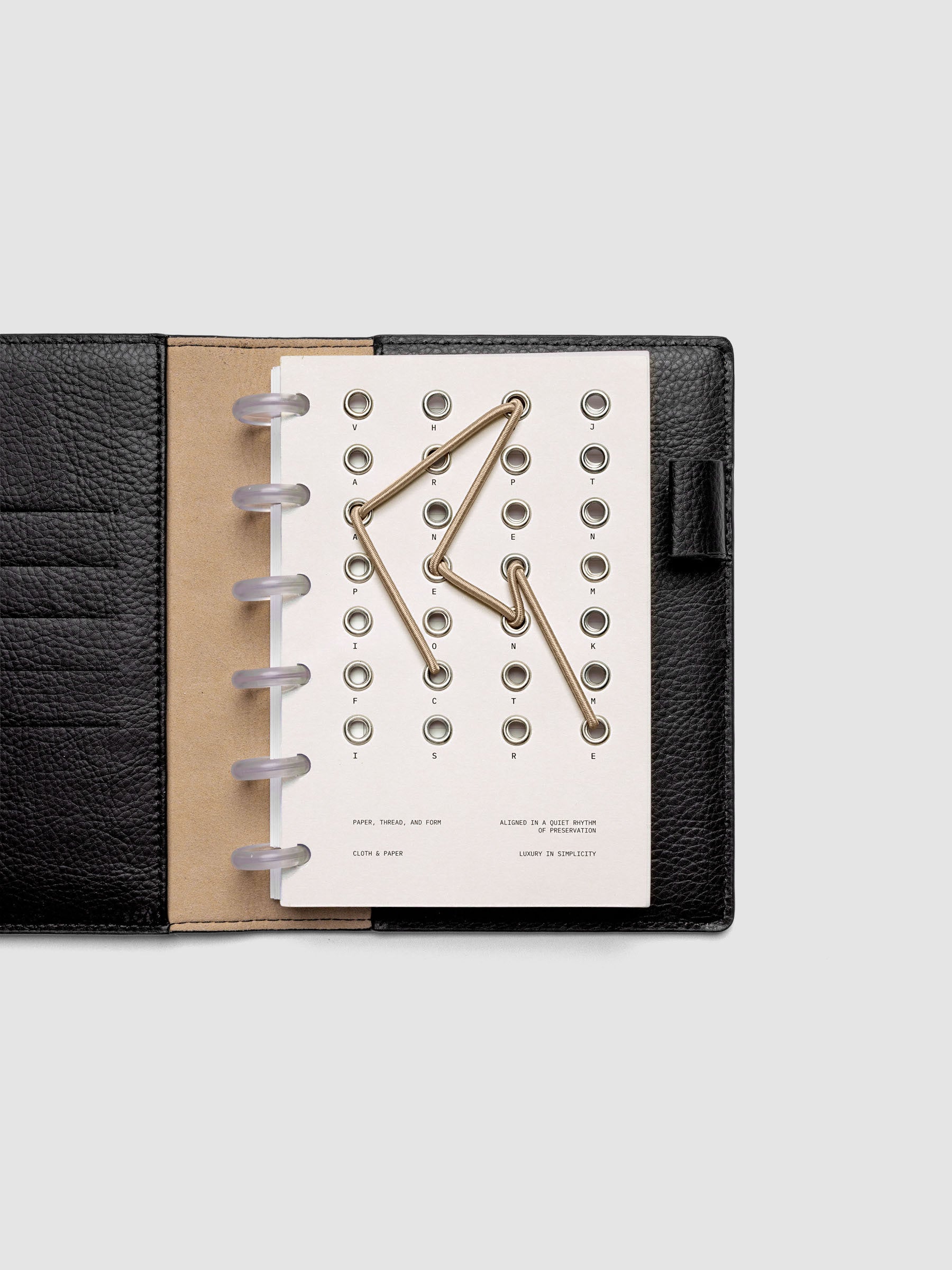 Cadence Dashboard with grommets and string on beige cardstock shown in size CP Petite for discbound planners and notebooks.