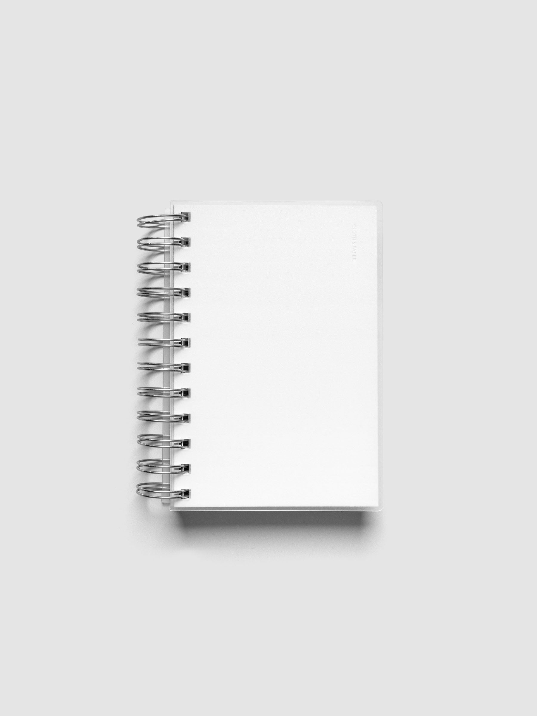 Spiral Notebook dashboard in the color Le Blanc shown in size CP Petite inside a notebook with the frosted transparent cover overlayed.