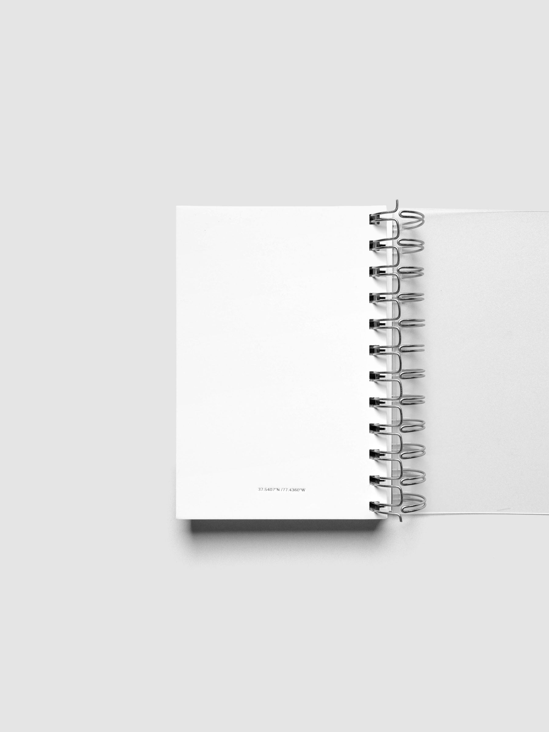 Spiral Notebook dashboard in the color Le Blanc shown in size CP Petite inside a notebook.