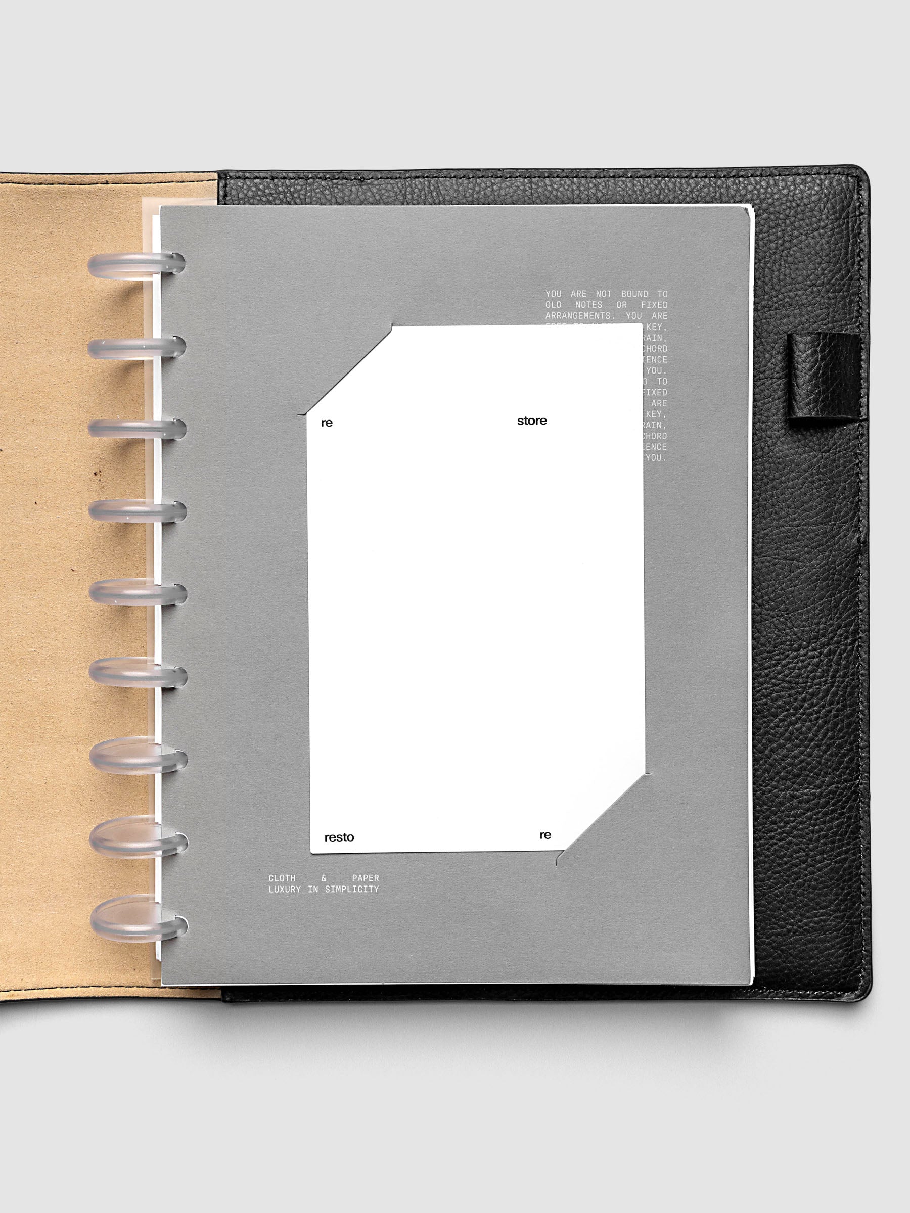 Grey cardstock planner dashboard with white plastic card inserted in slits with white printed text shown in size HP Classic in a discbound planner.