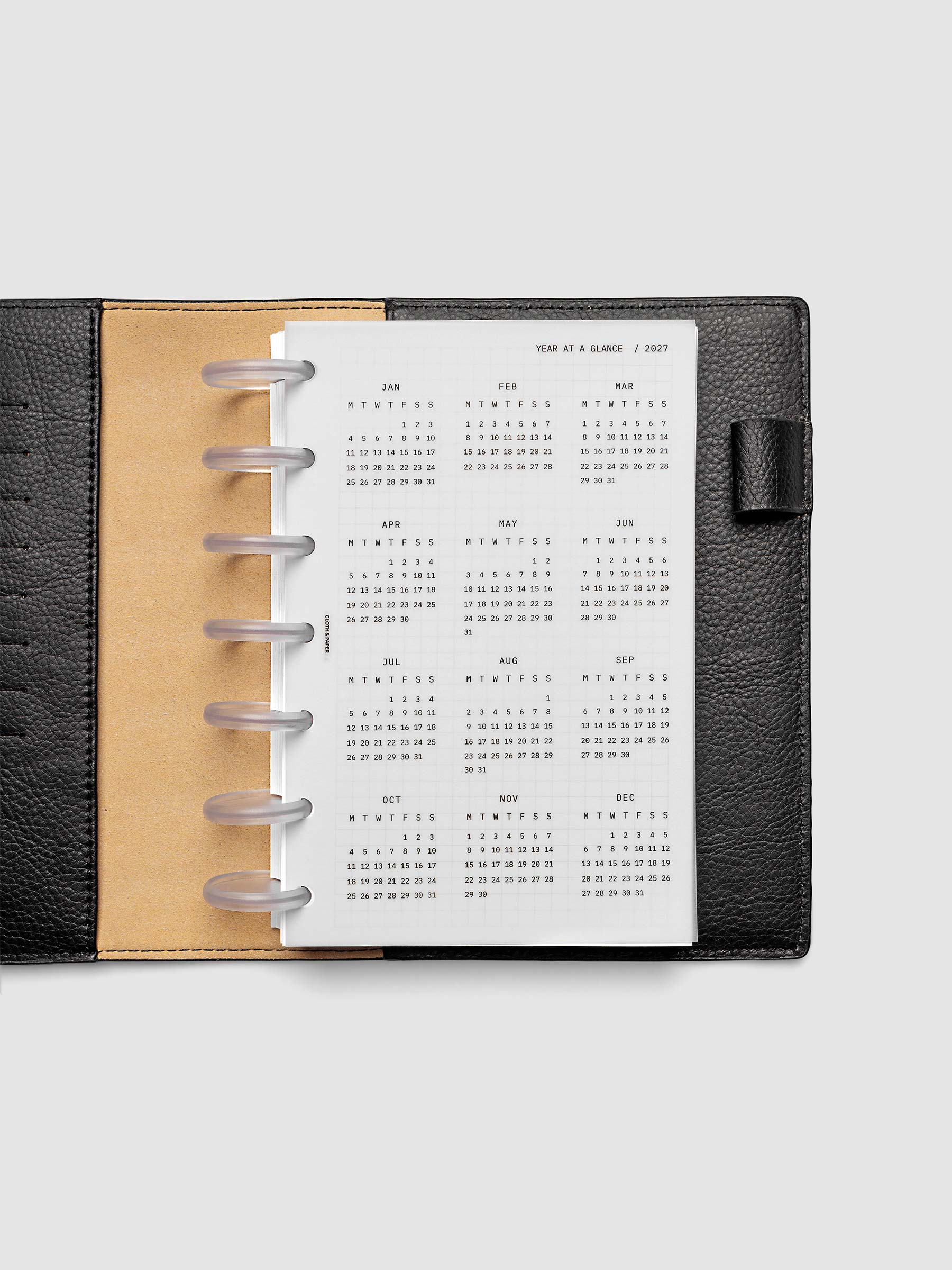 2027 Year At A Glance Dashboard Monday Start, HP Mini 7-Disc Punch, translucent vellum year-at-a-glance calendar shown inside a planner