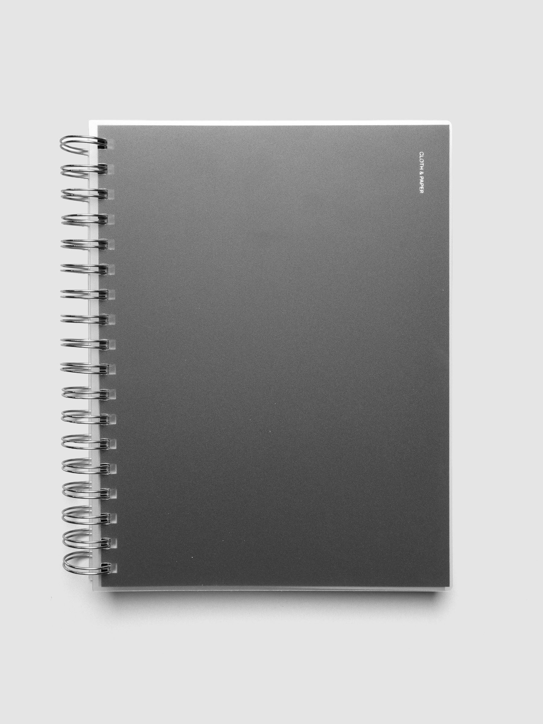 Spiral Notebook dashboard in the color Avant Garde shown in size HP Classic inside a notebook with the frosted transparent cover overlayed.