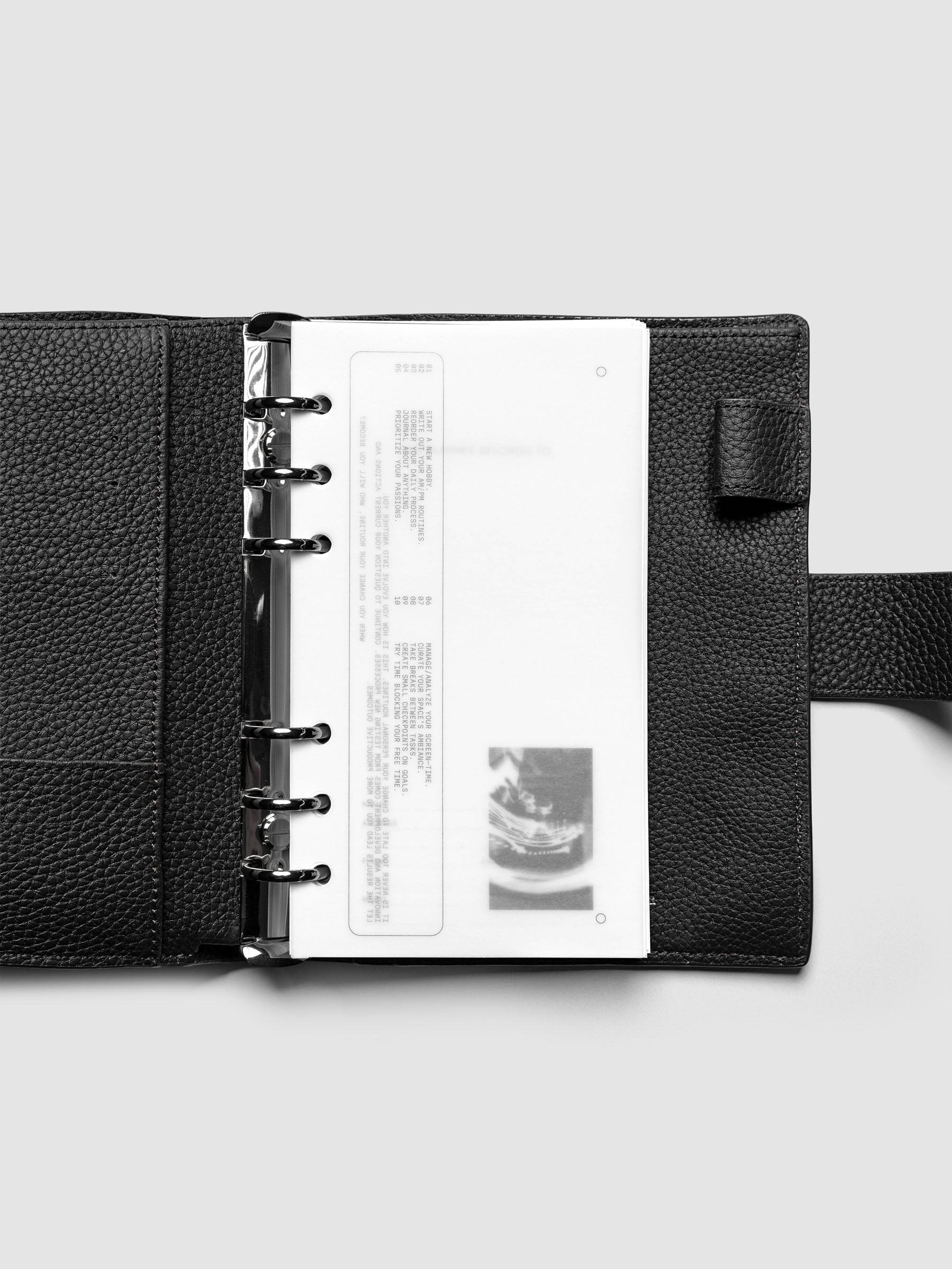 Side A & Side B Planner Dashboard in size Personal shown in a black agenda.