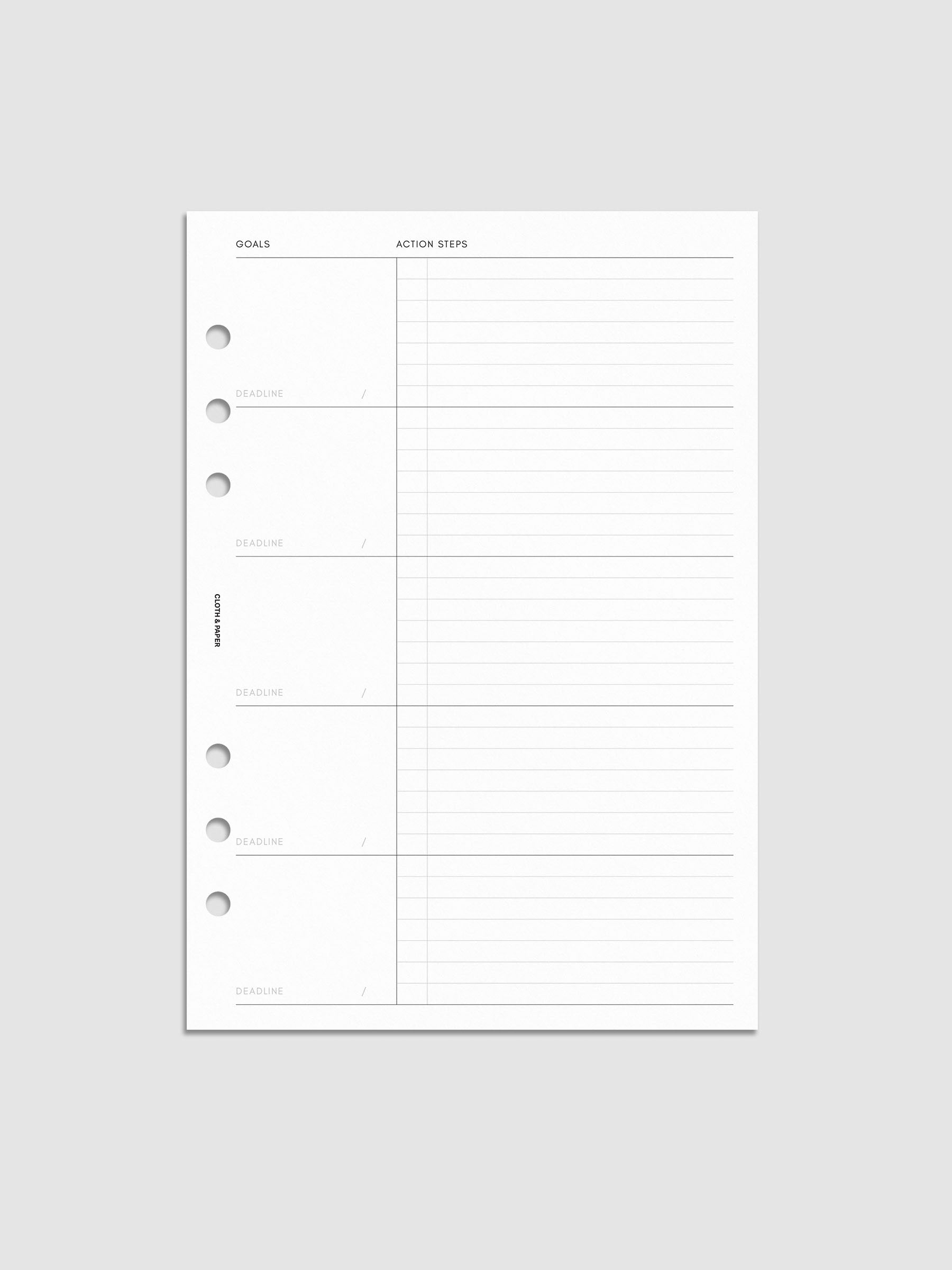 A blank planner page with sections for goals, deadlines, and action steps, featuring six holes for binder insertion. The left side has labeled boxes for goals and deadlines, while the right side has lined space for action steps.