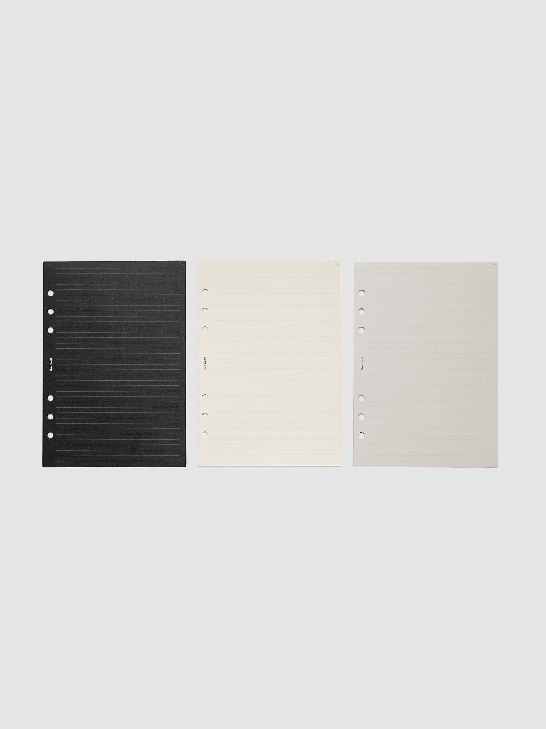 Black, Grey, and Cream Colored Planner Inserts with Perforated Corners shown in A5 6-Ring Punch.