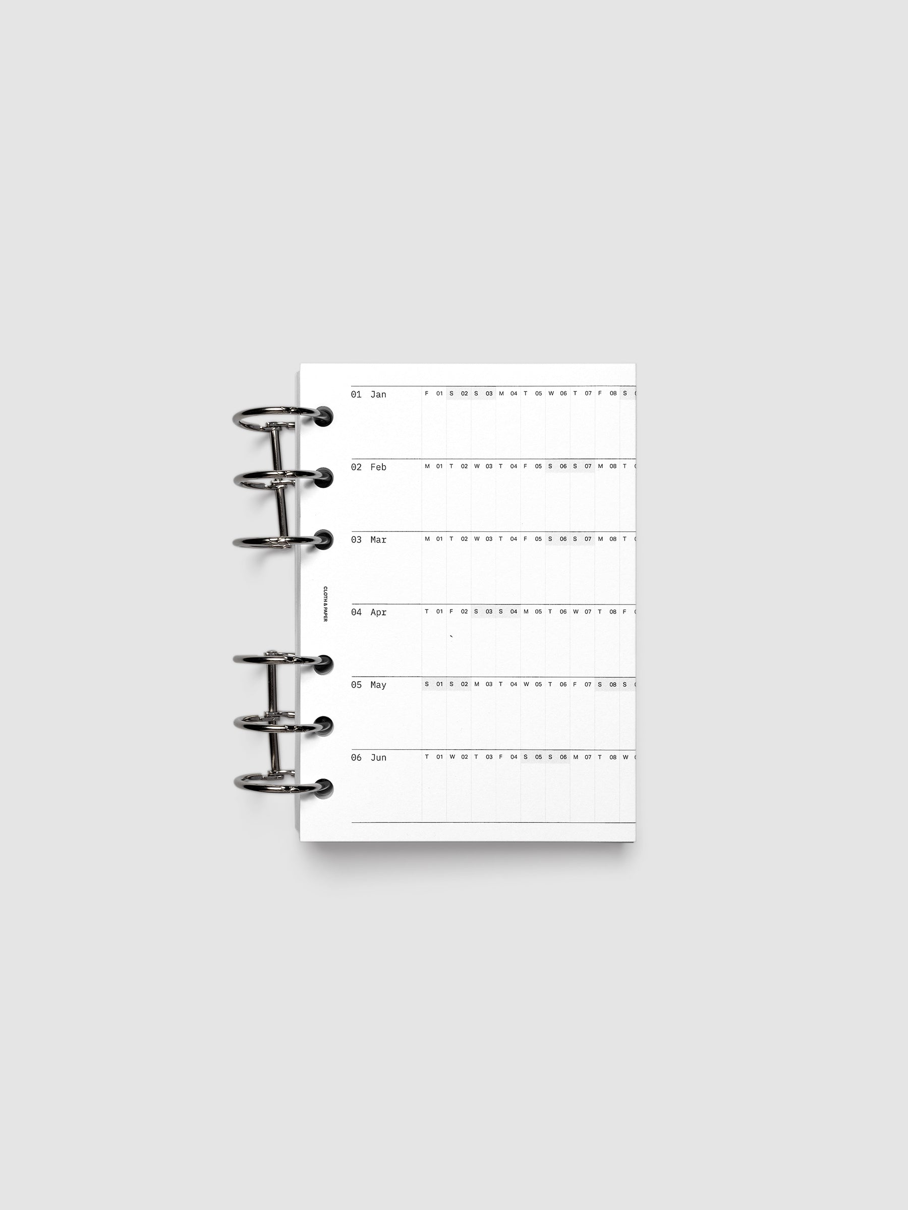 2027 Dated Fold Out Insert tucked into a A6 6-Ring Punch 6-ring planner, shown closed.
