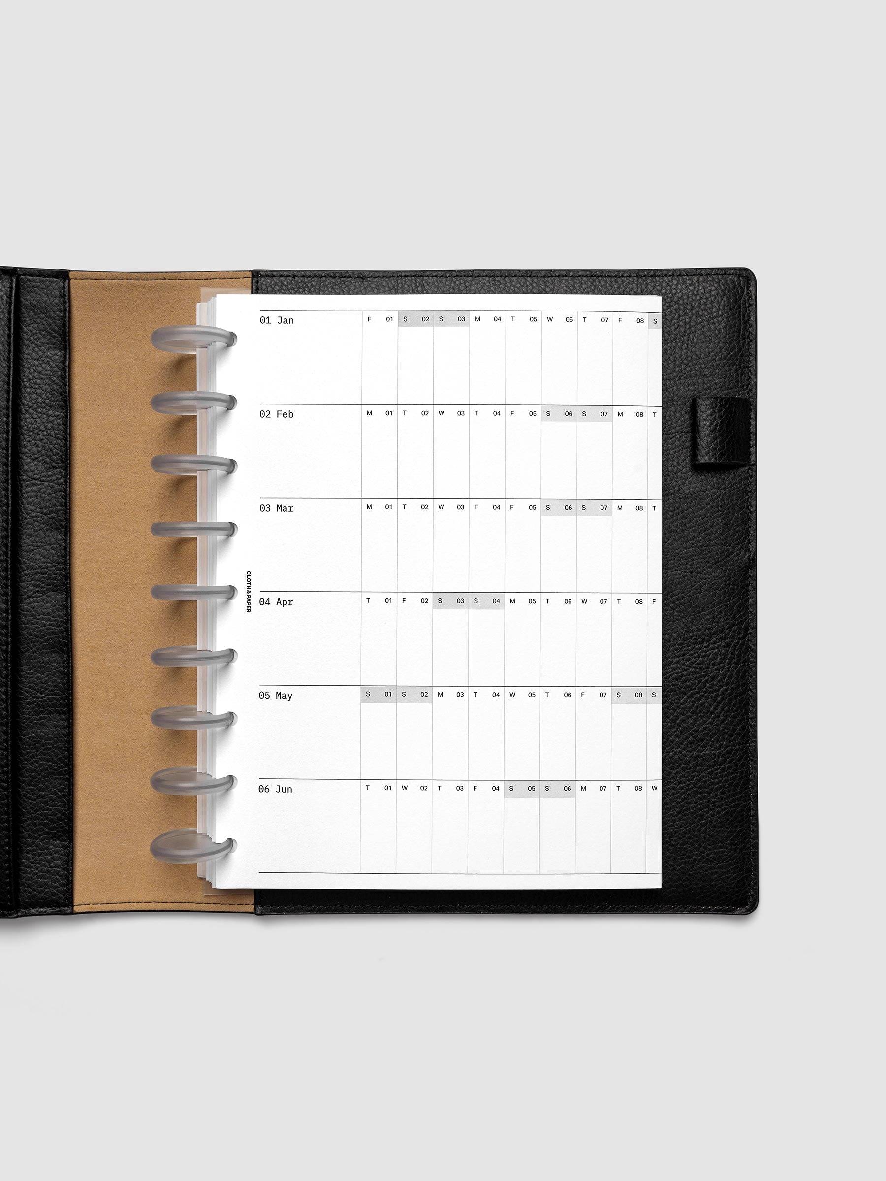2027 Dated Fold Out Insert tucked into a HP Classic 9-Disc Punch discbound planner, shown closed.