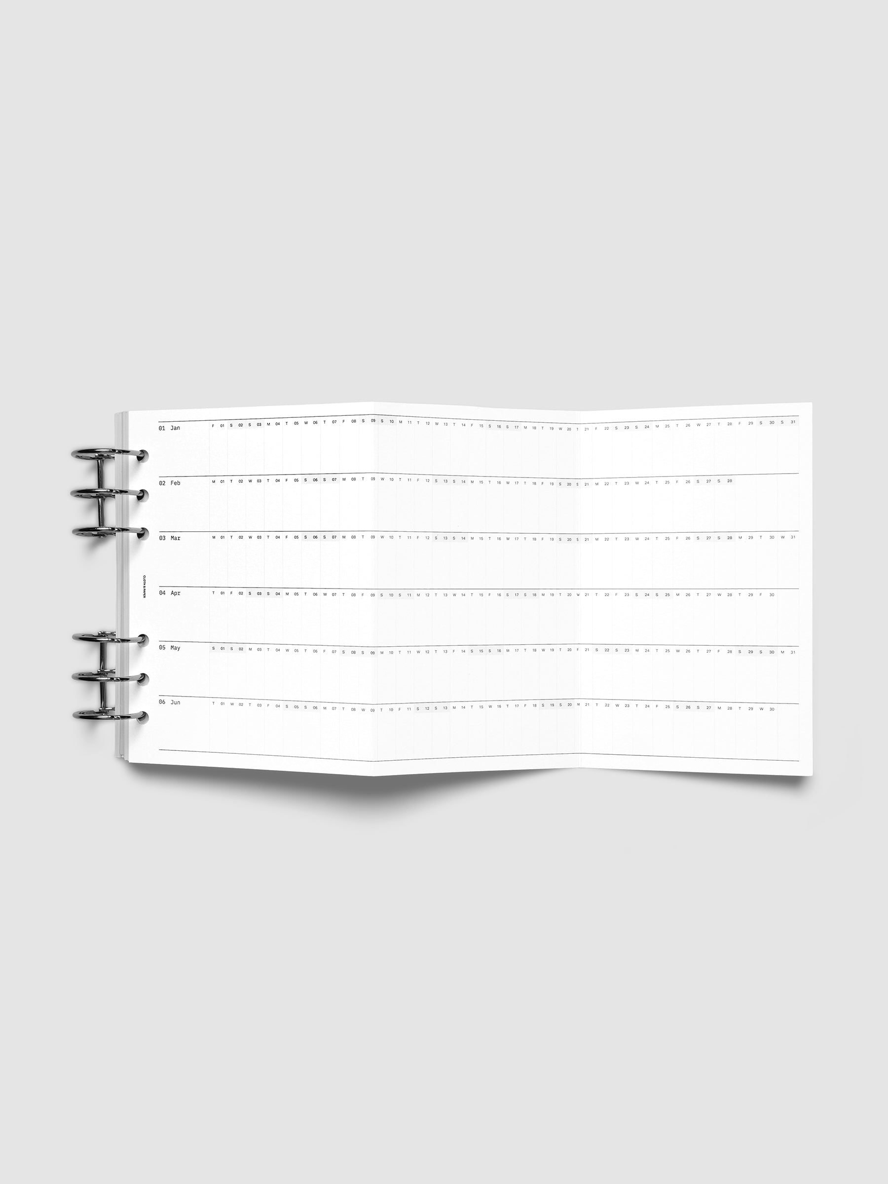 2027 Dated Fold Out Insert fully unfolded inside a Personal Wide 6-Ring Punch 6-ring planner, showing six months of dated calendar boxes across one side.