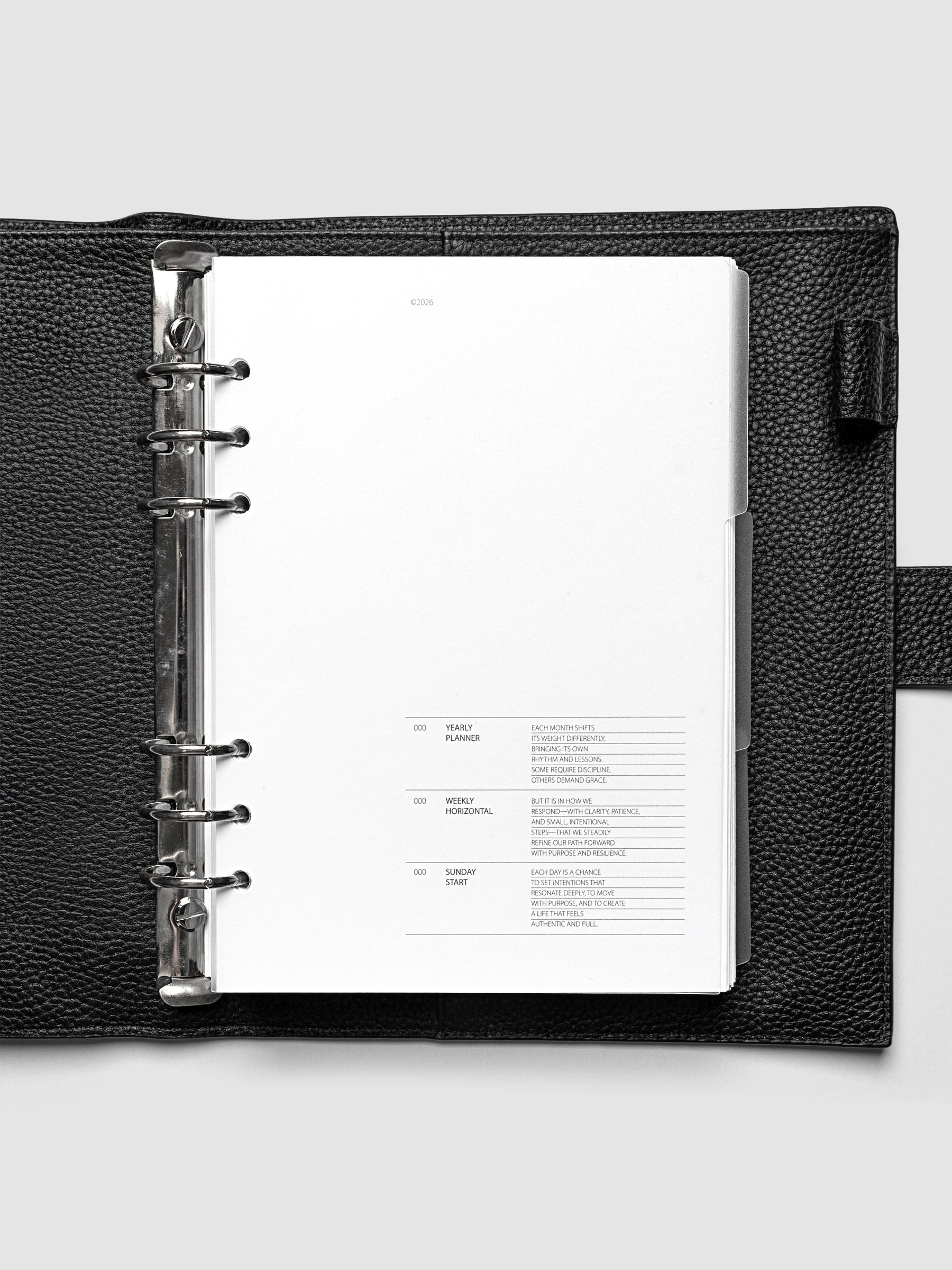 Blank, transparent side tab divider set shown in an A5 planner.