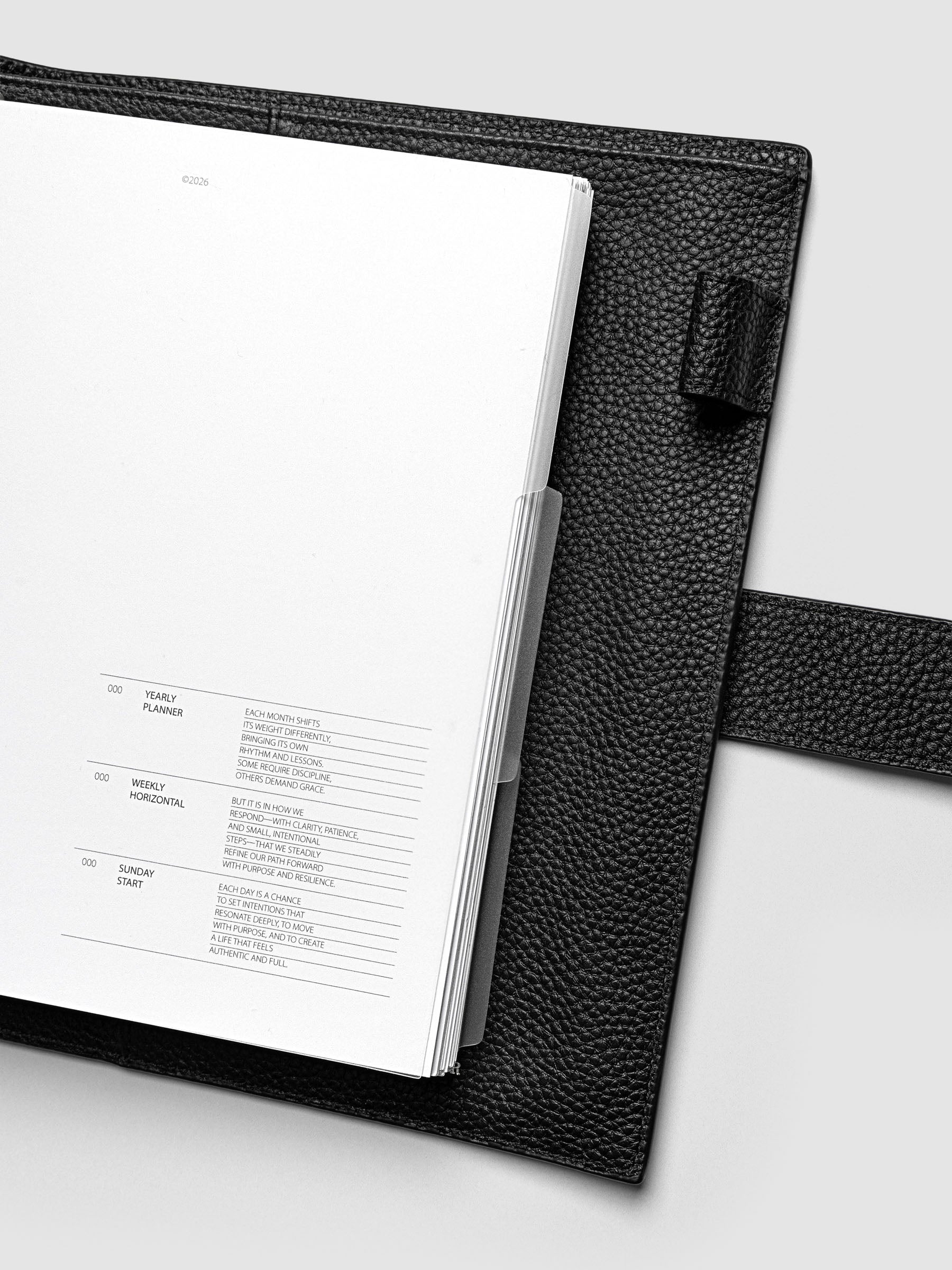 Blank, transparent side tab divider set shown in an A5 planner.
