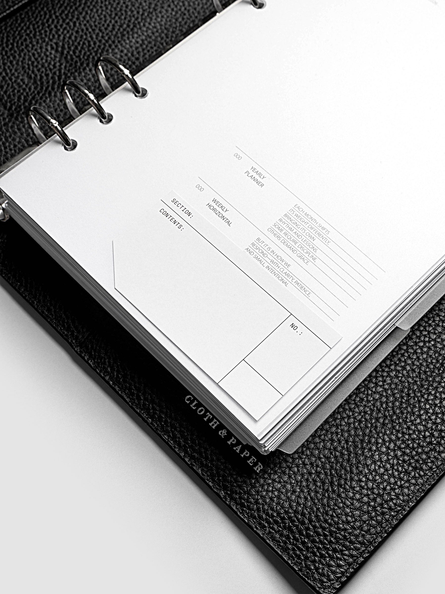 Clear side tab dividers sized for A5 planners shown in use with a blank label with headers section, content, and no.