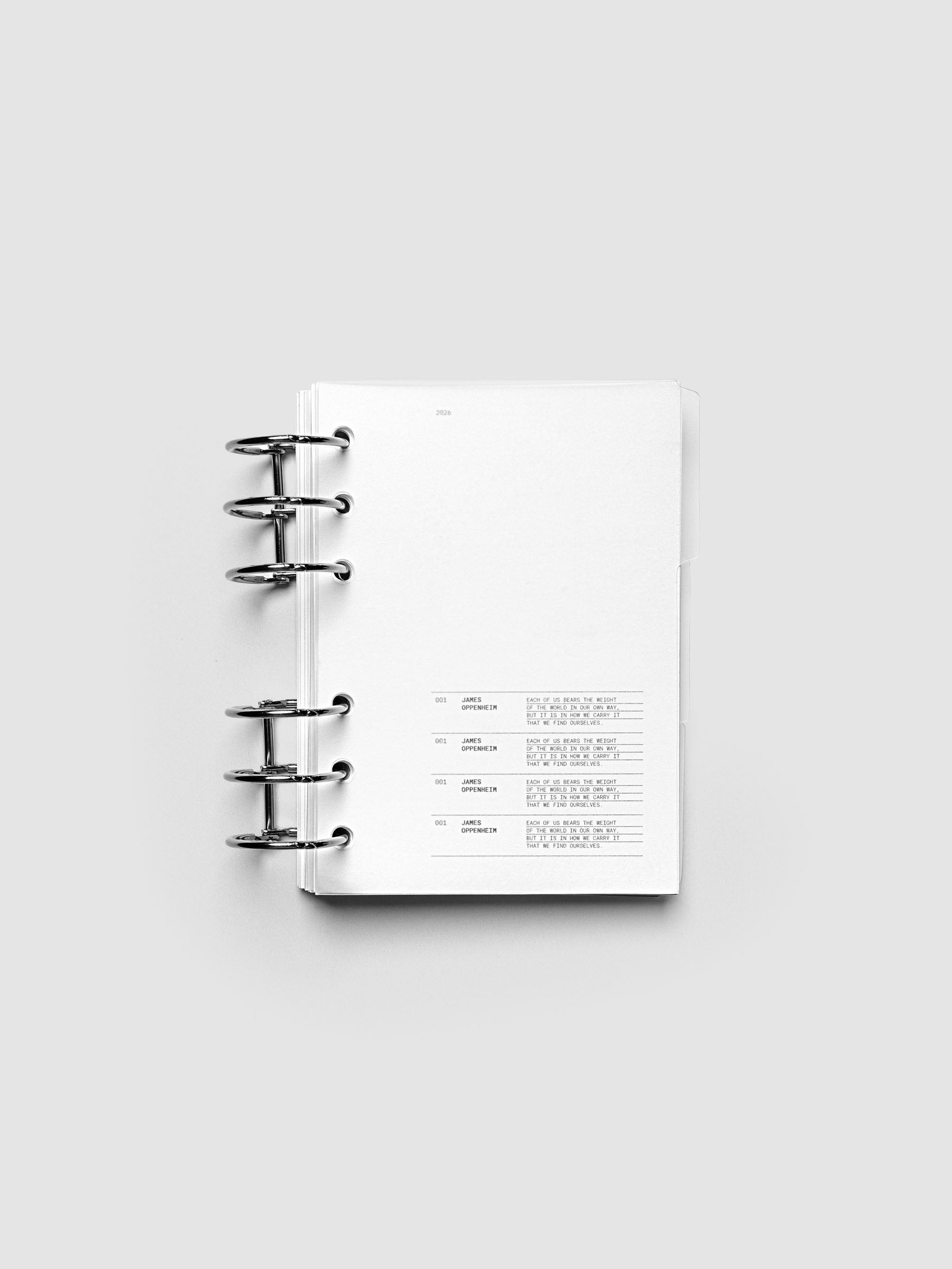 Blank, transparent side tab divider set shown in an A6 planner.