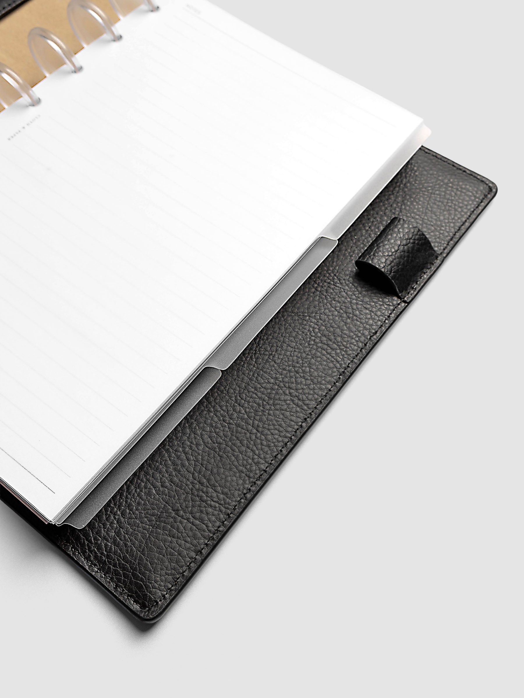 Blank, transparent side tab divider set shown in a Half Letter planner.
