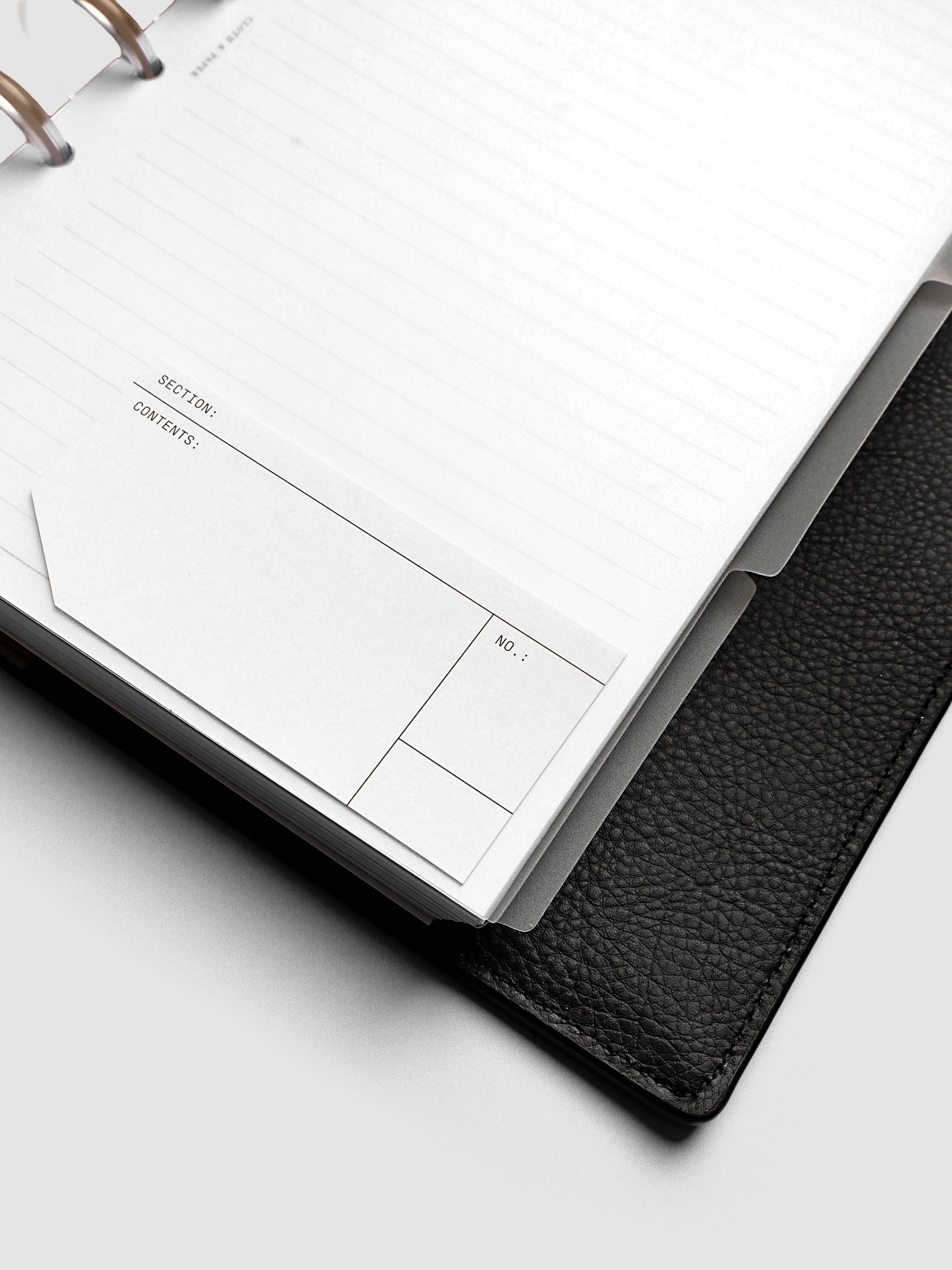Blank, transparent side tab divider set shown in a Half Letter planner with a blank label affixed.
