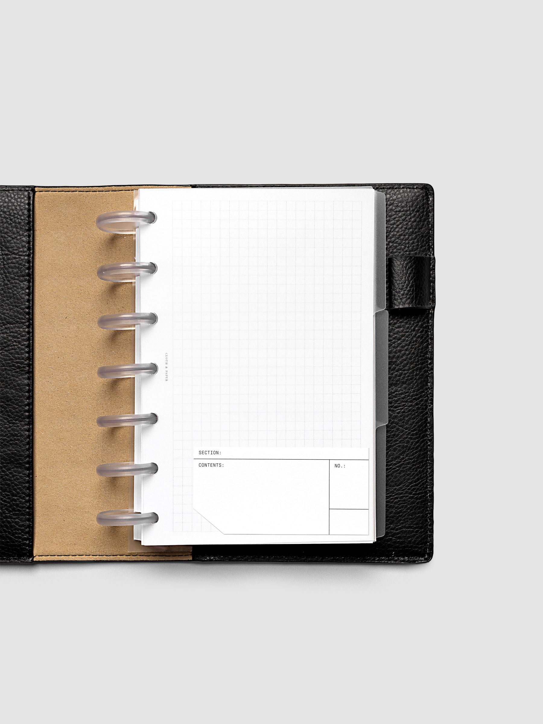 Blank, transparent side tab divider set shown in an HP Mini planner shown with a label affixed.