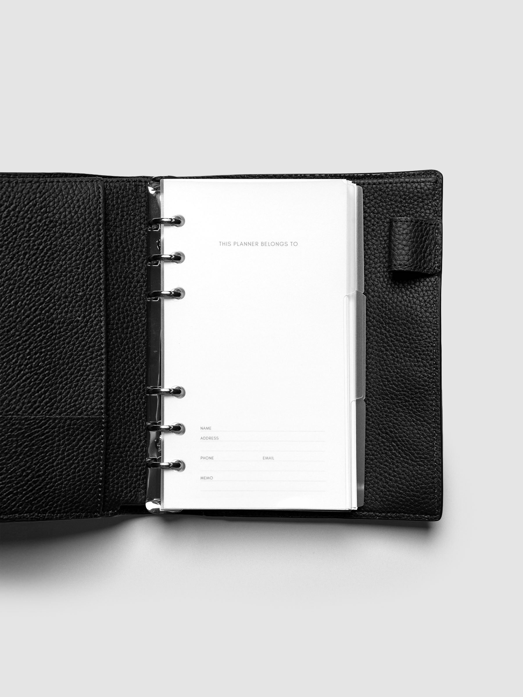 Blank, transparent side tab divider set shown in a Personal planner.